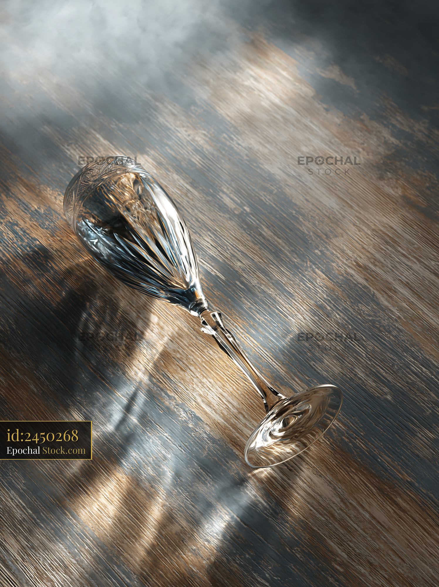 Empty crystal champagne glass lying on a weathered wooden table - stock photo