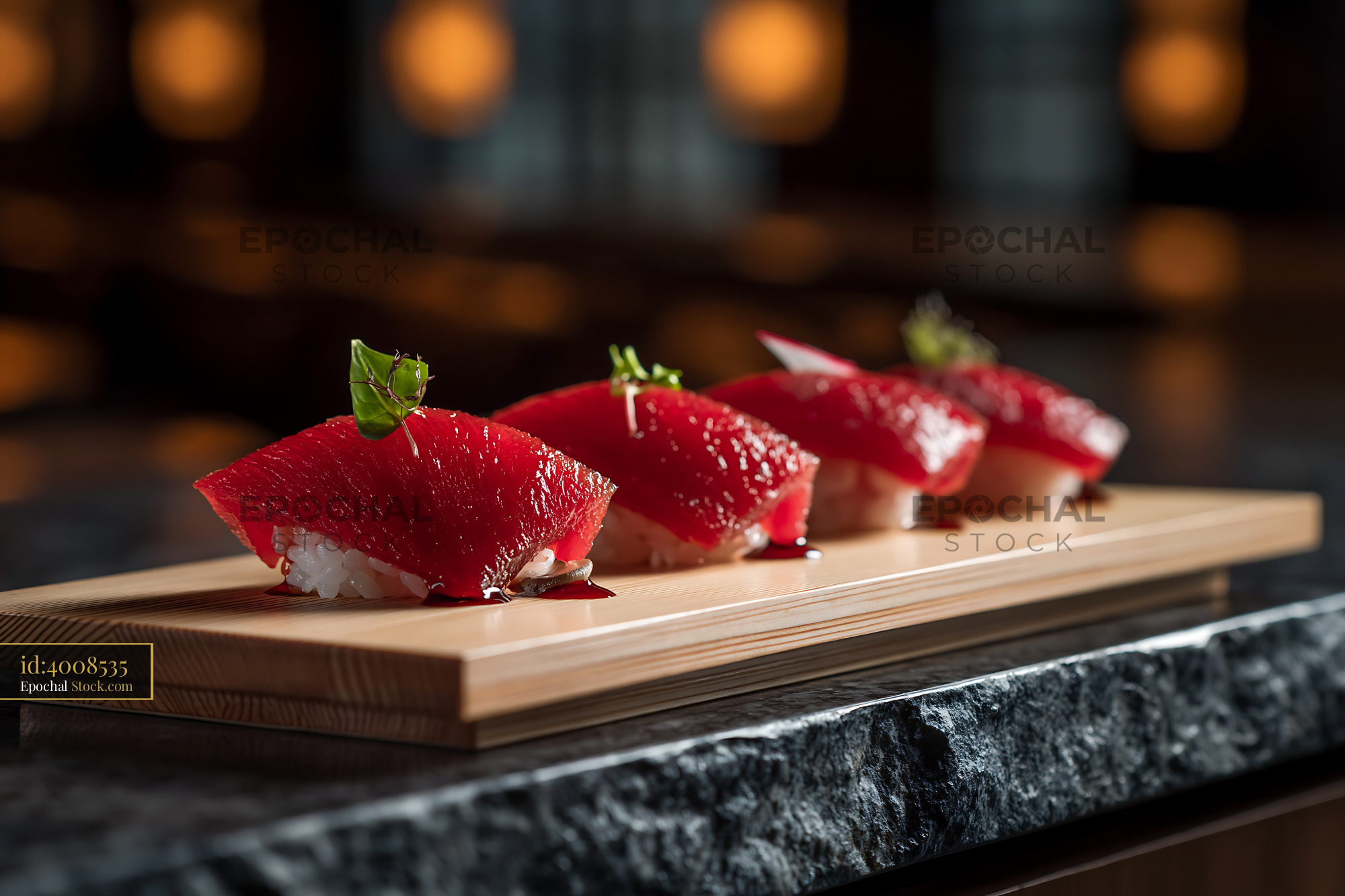 Watermelon tuna sushi nigiri on wooden board in a dark restaurant - stock photo