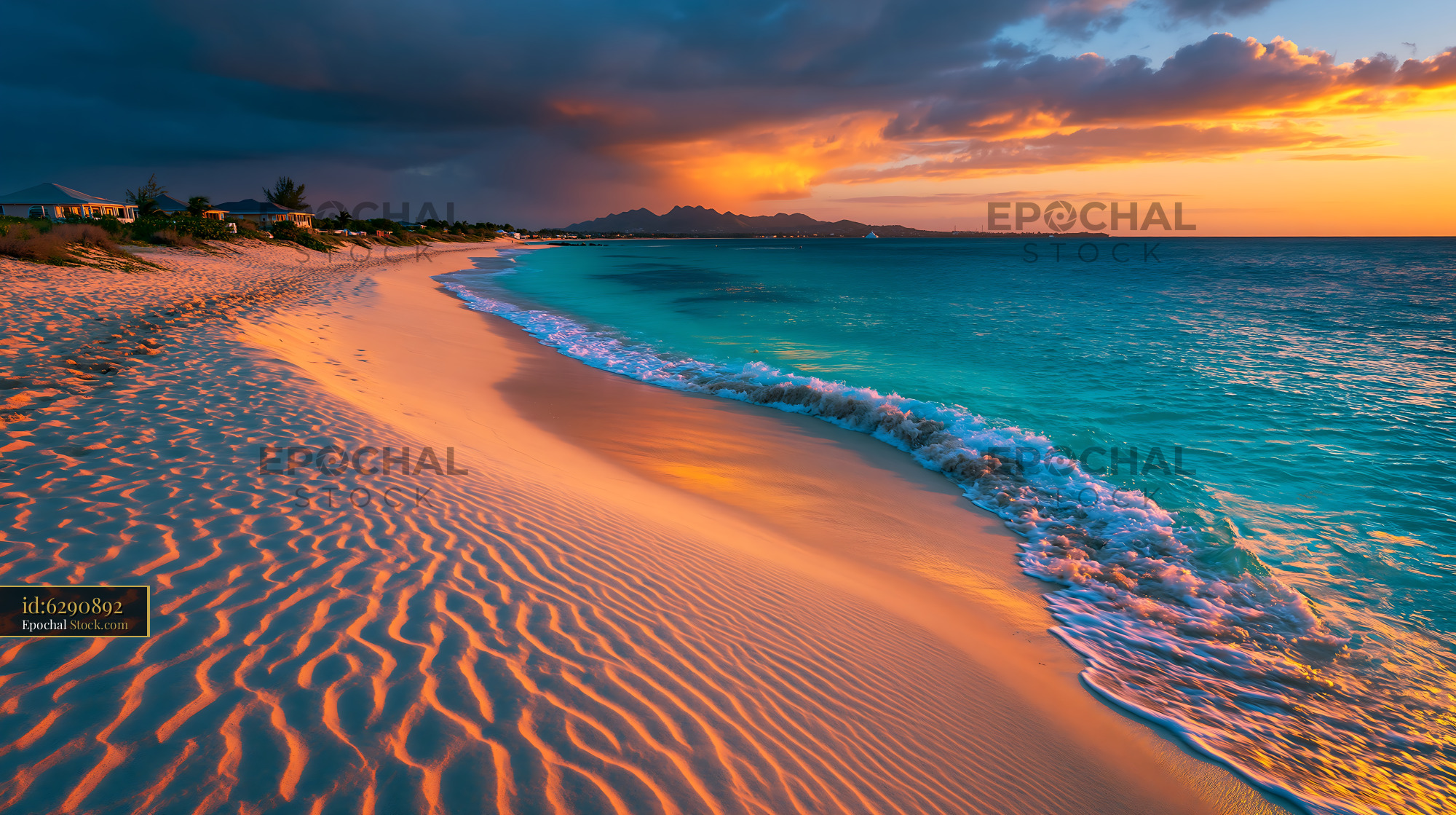 Tropical beach with sand ripples at sunset under a dramatic sky - stock photo