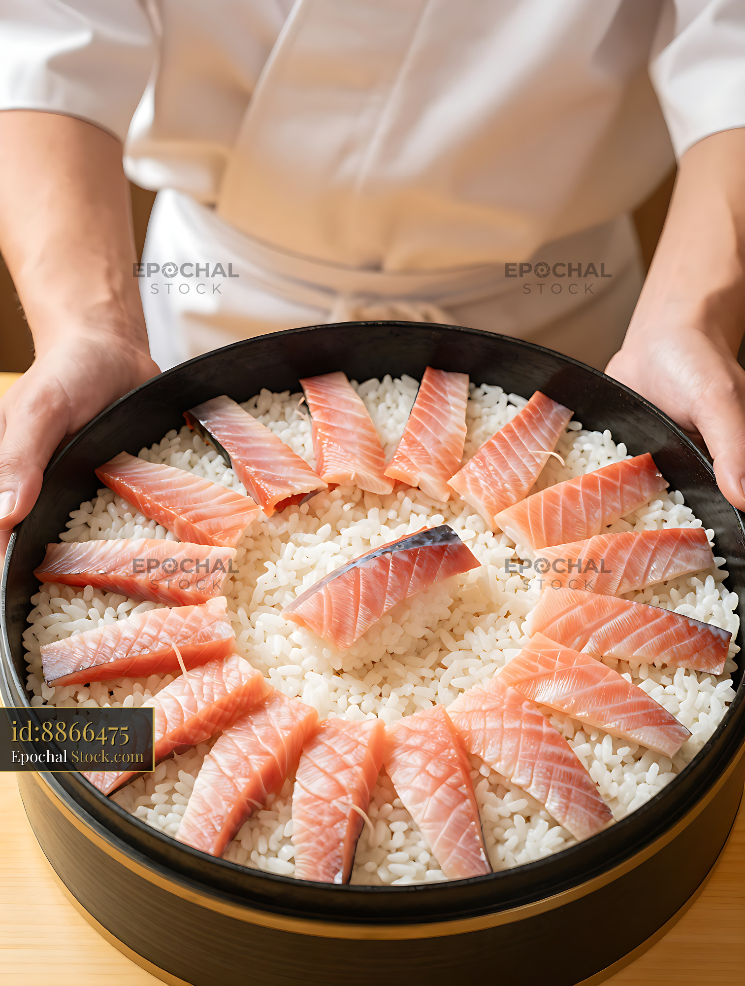 Chef presenting traditional Masuzushi trout sushi in a wooden tub - stock photo