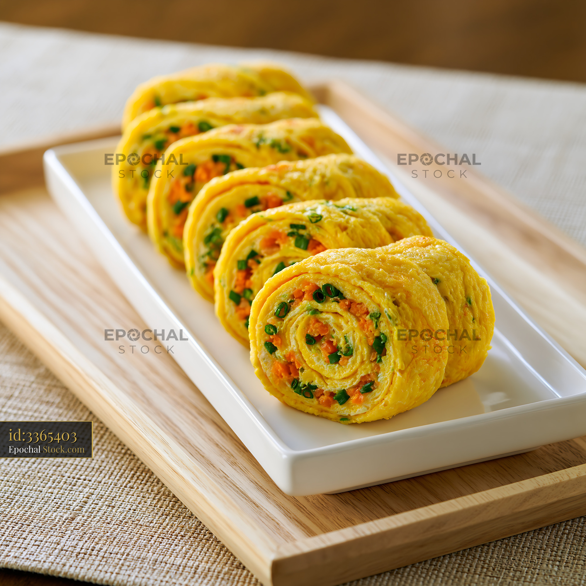 Korean rolled omelet gyeran mari with vegetables on a white plate - stock photo