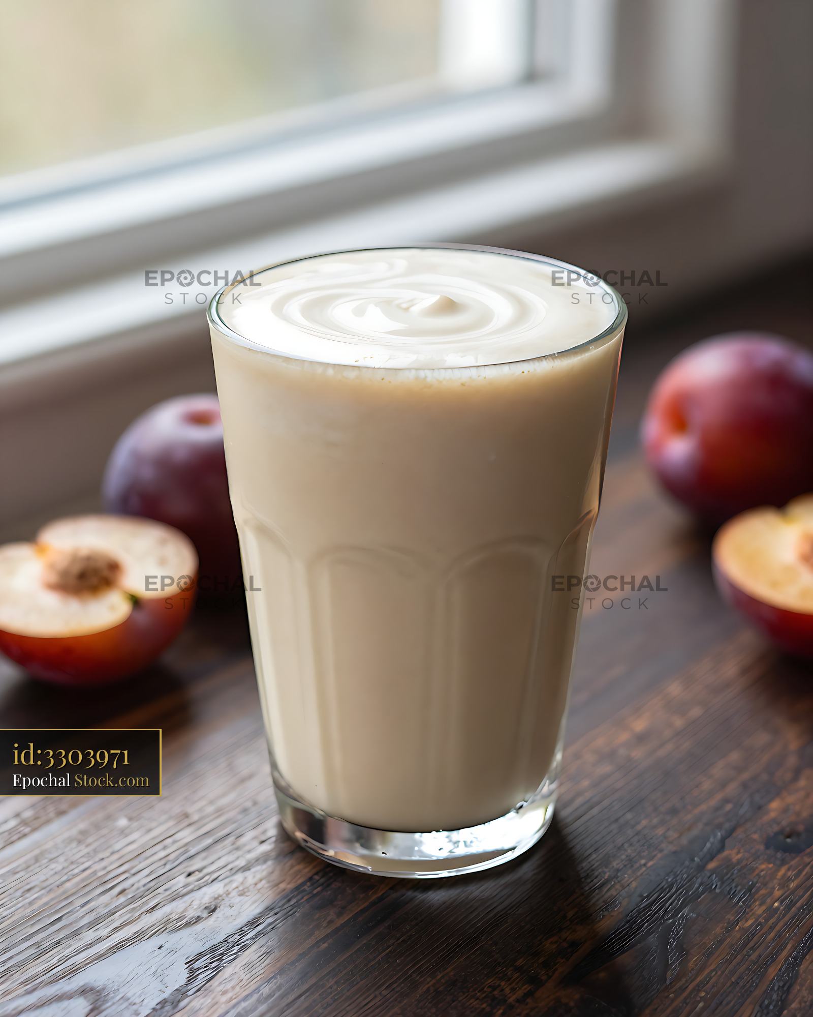 Damson dewdrop smoothie in a glass with fresh plums on wood - stock photo