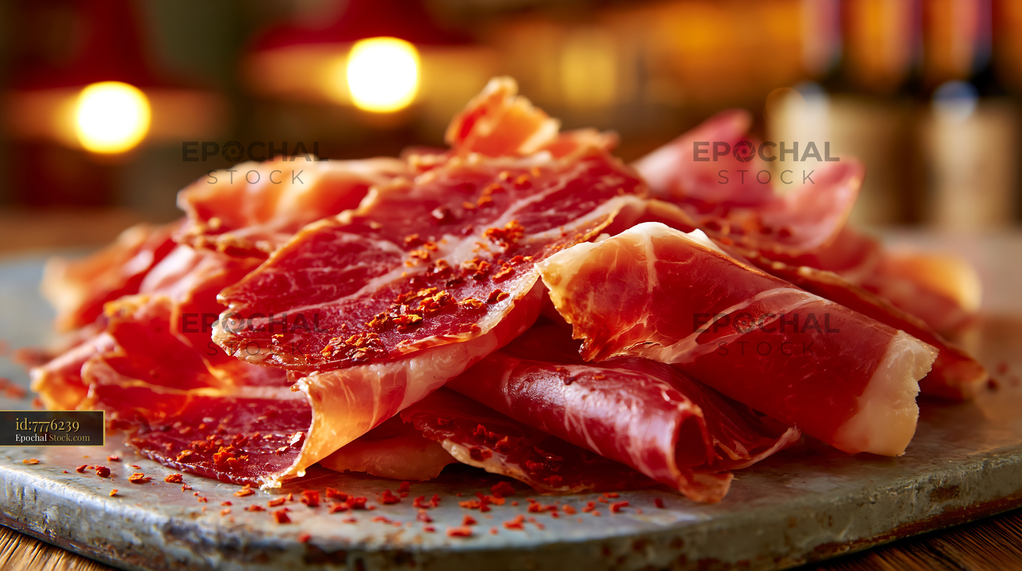 Thin slices of jambon de bayonne meat sprinkled with chili flakes - stock photo