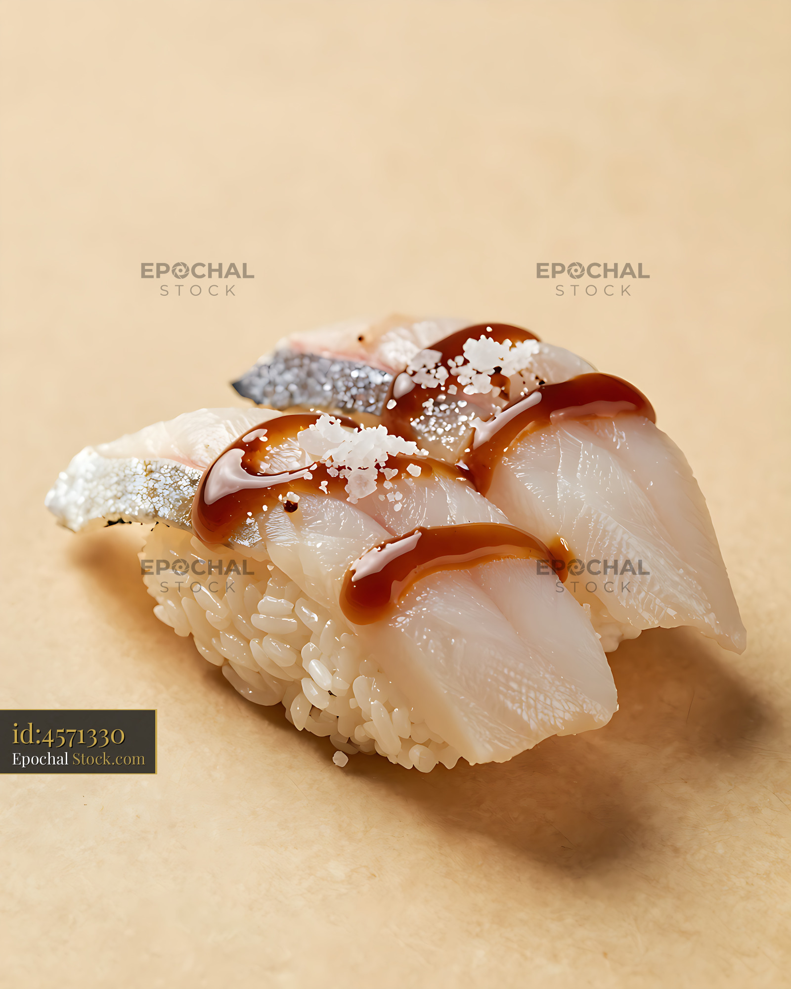 Two pieces of fresh engawa nigiri sushi with glaze and sea salt - stock photo