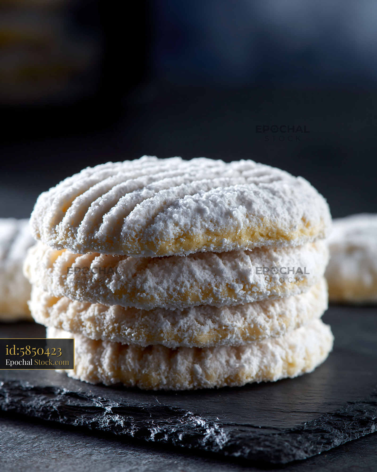 Un kurabiyesi biscuits stacked on dark slate with powdered sugar - stock photo