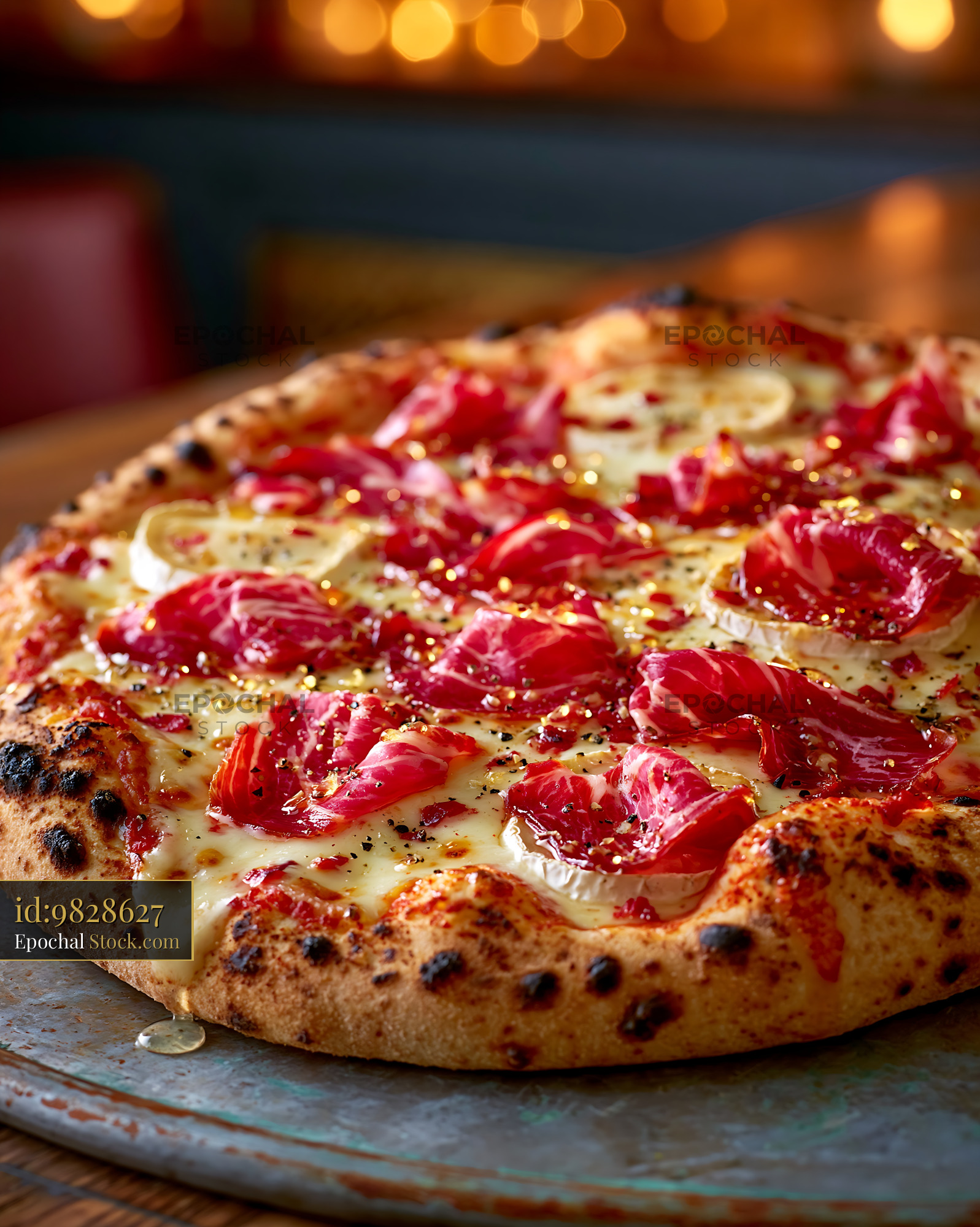 Gourmet speck brie pizza with honey in a cozy restaurant - stock photo