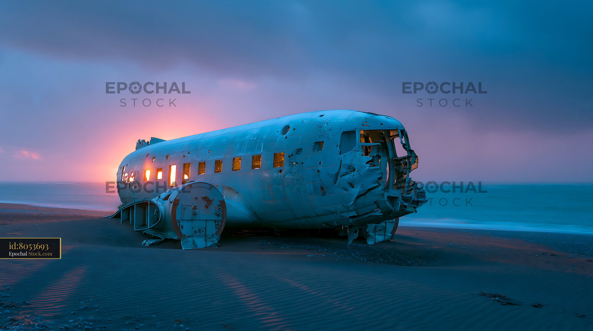 Abandoned plane wreck on a black sand beach during sunset - stock photo