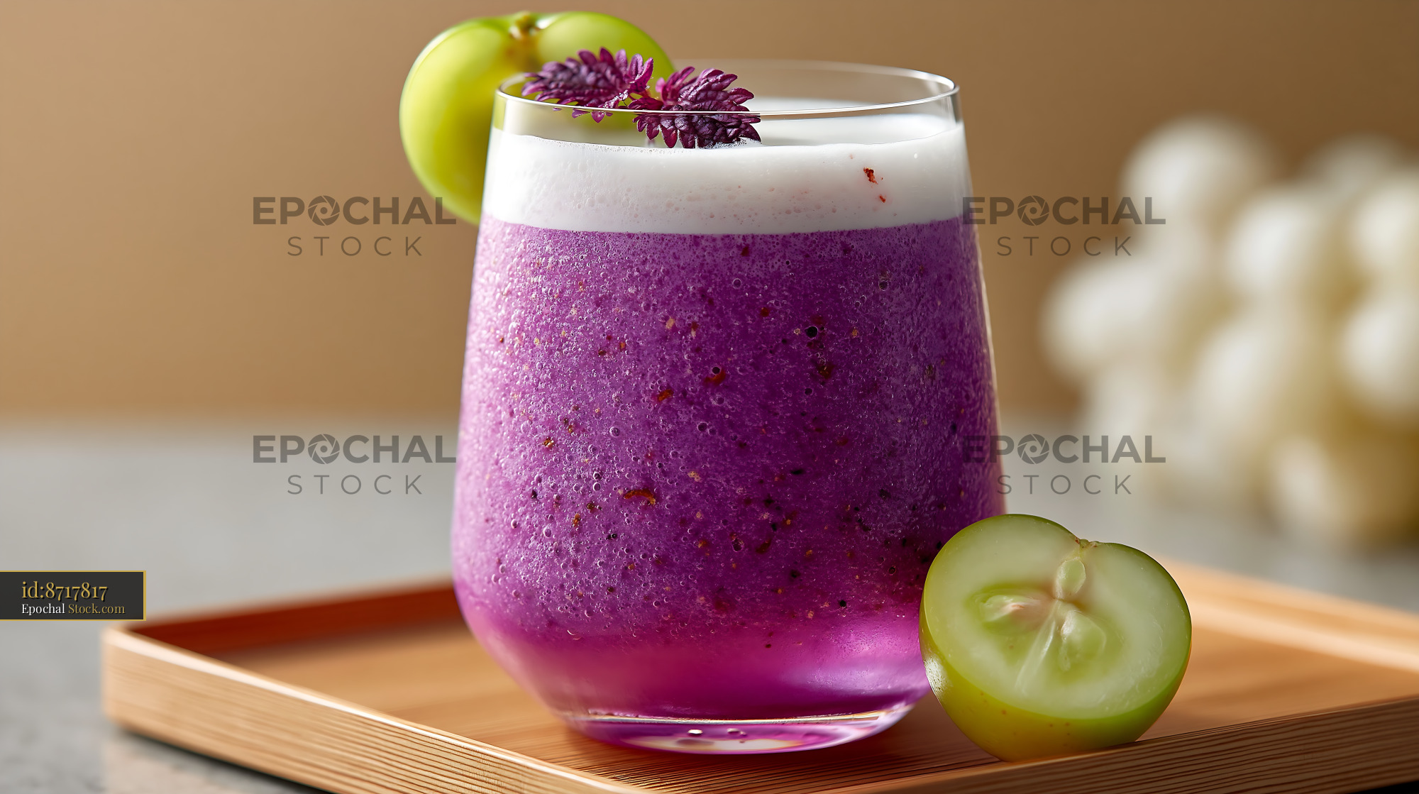 Refreshing kyoho grape smoothie with foam and green grape garnish - stock photo