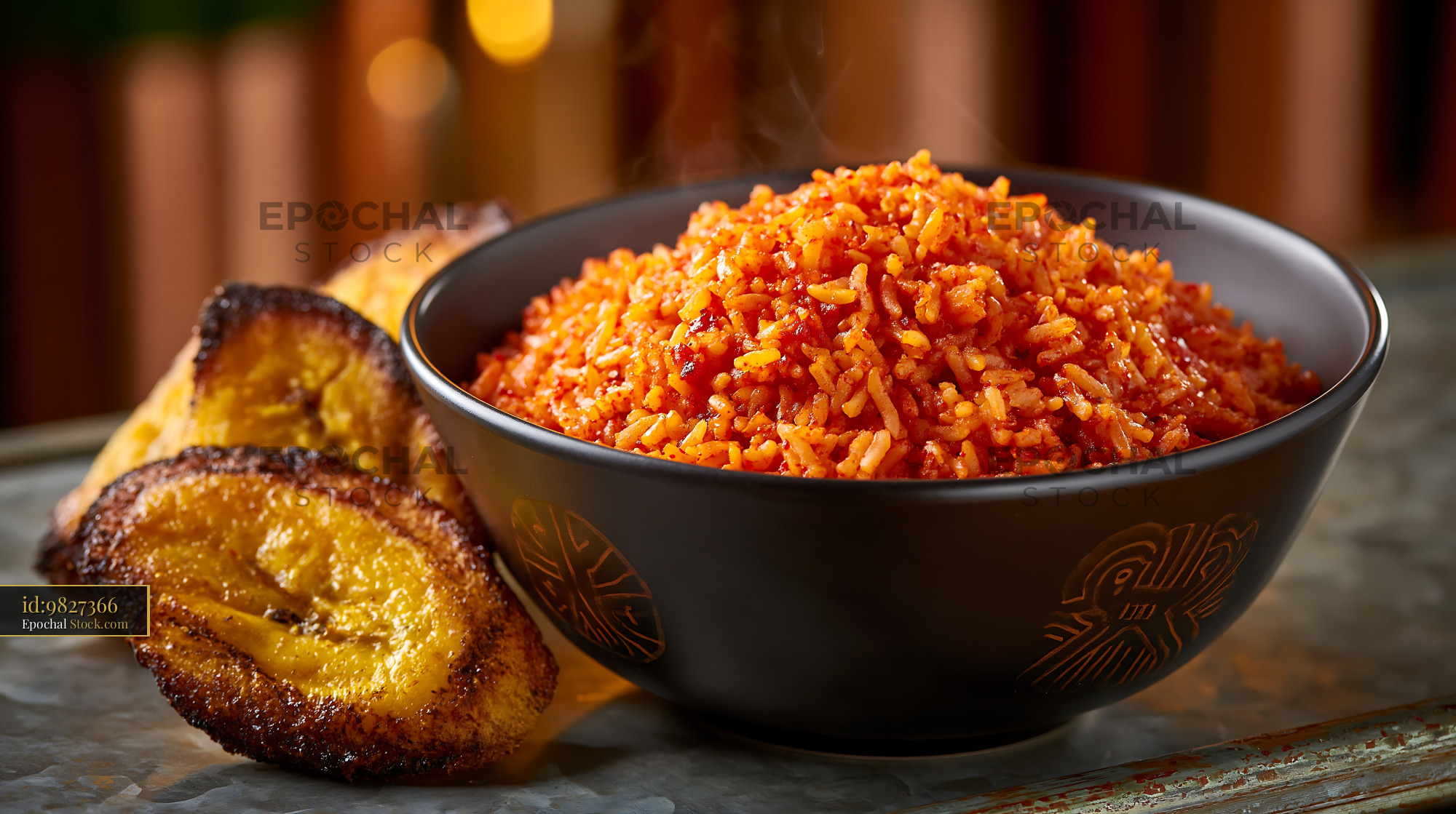 Steaming bowl of West African jollof rice with fried plantains - stock photo