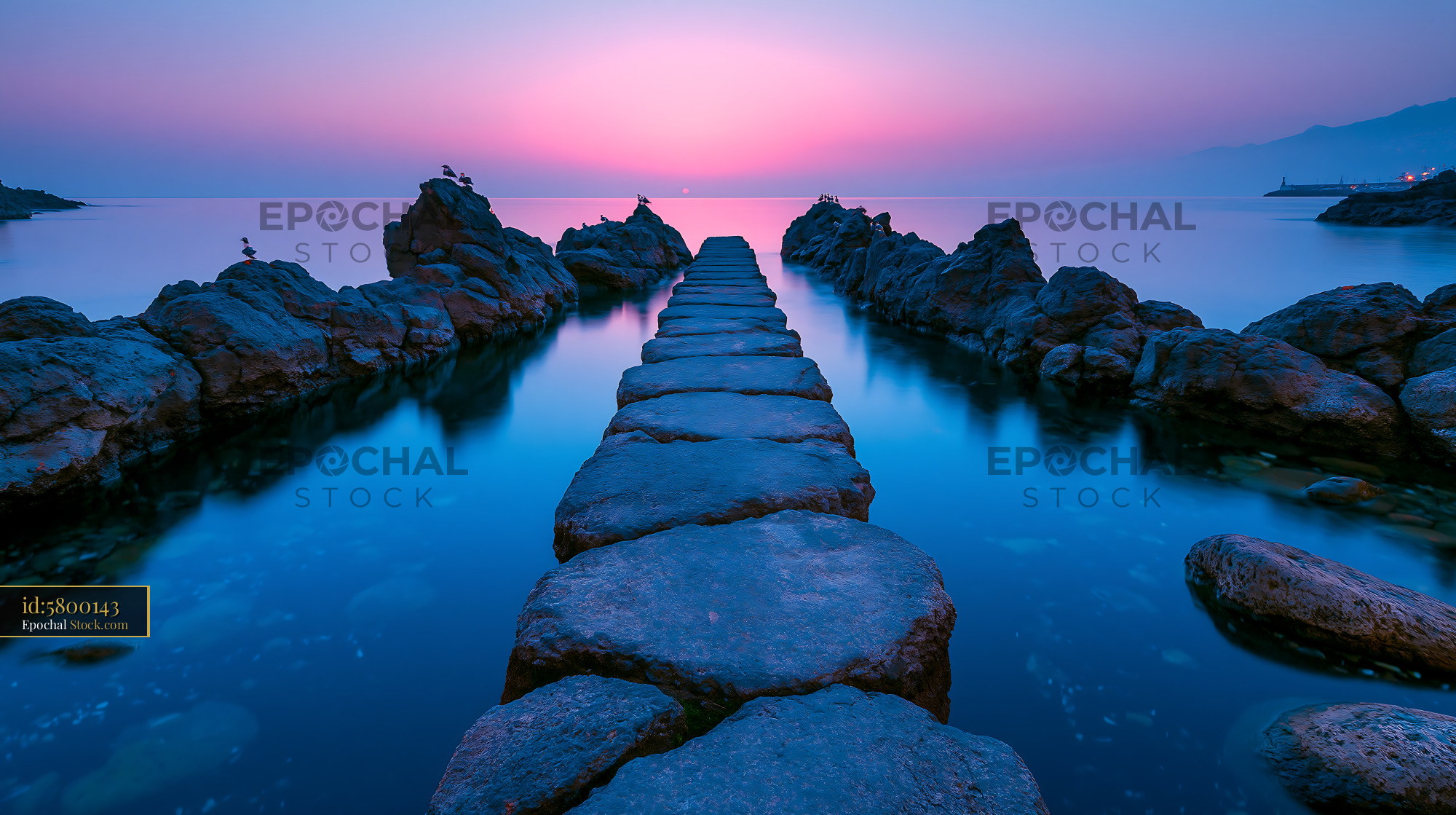 Stone path leading into the ocean at Los Cancajos during sunset - stock photo