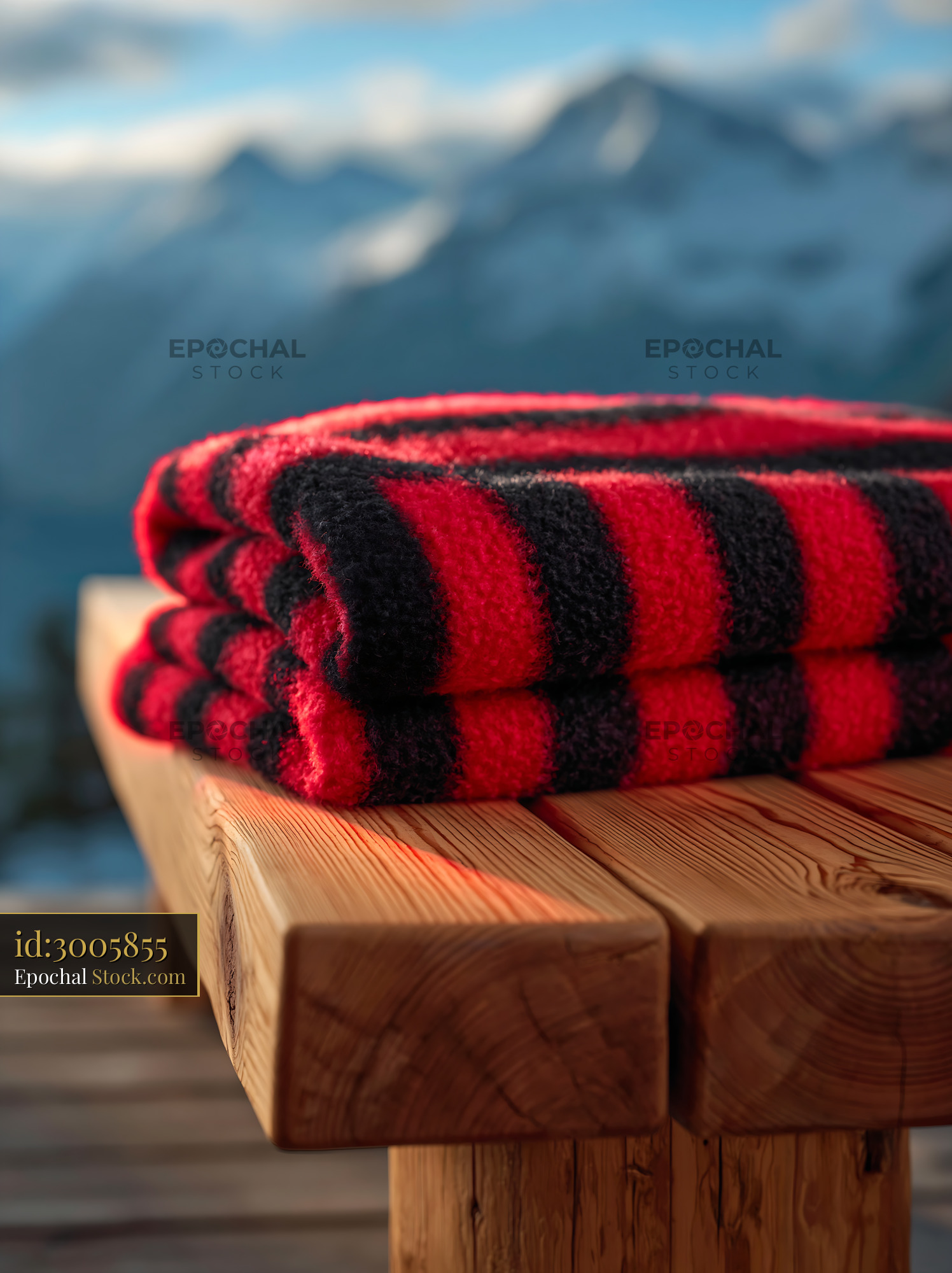 Striped throw on bench with snowy mountain background - stock photo