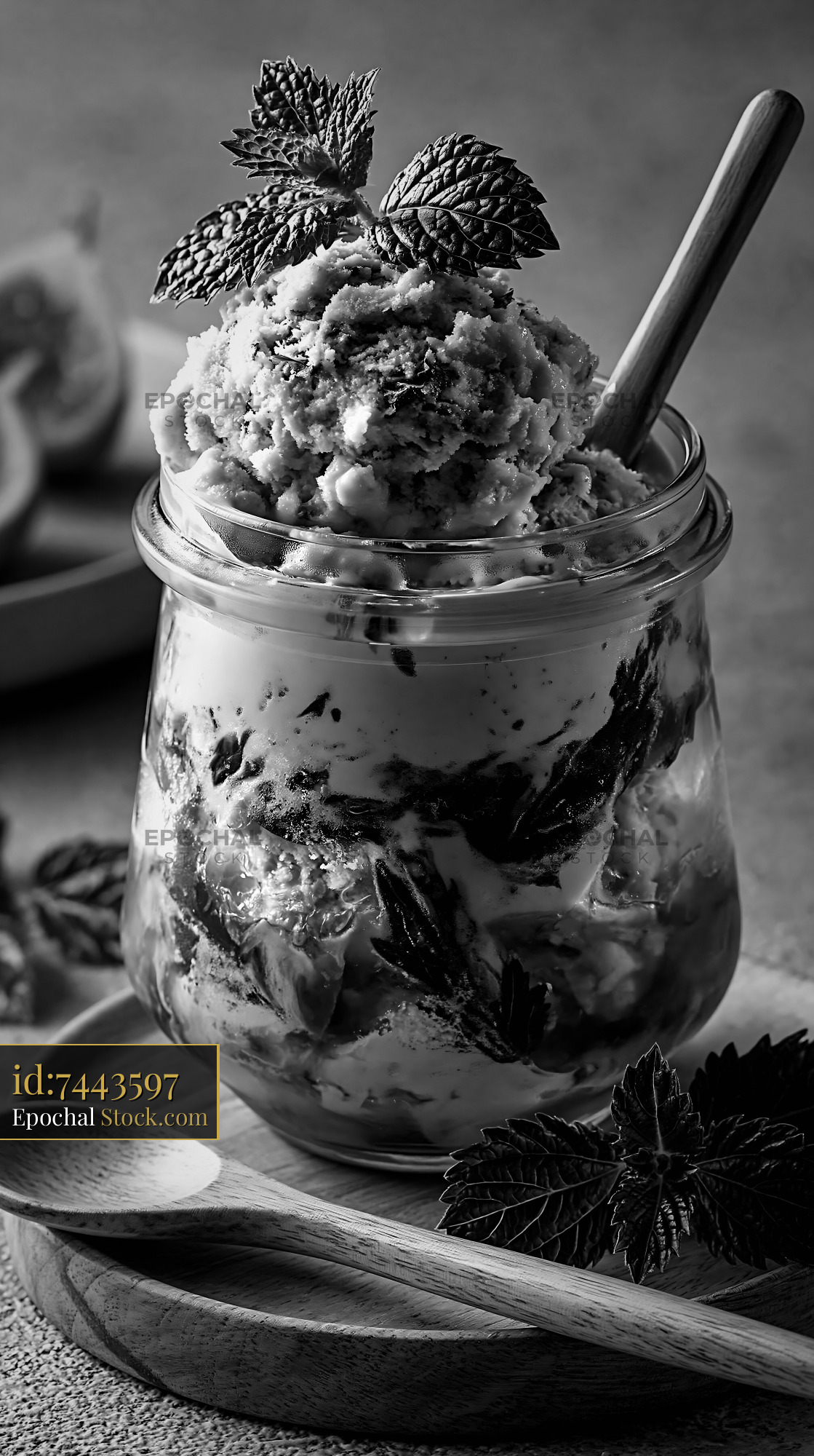 Artisanal fig leaf ice cream in a glass jar with fresh garnish - stock photo