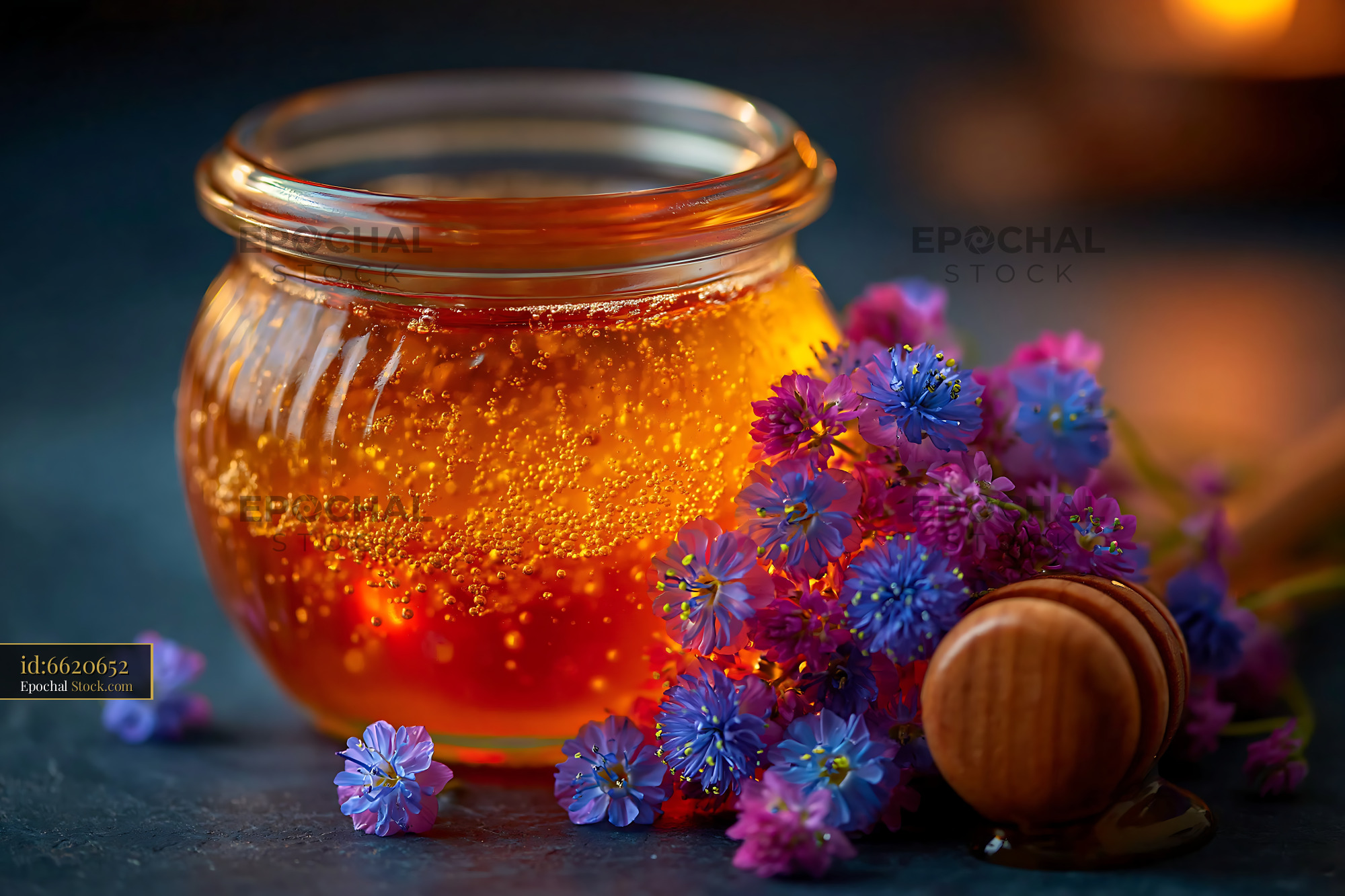 Artisanal honey jar with wildflowers and wooden dipper - stock photo