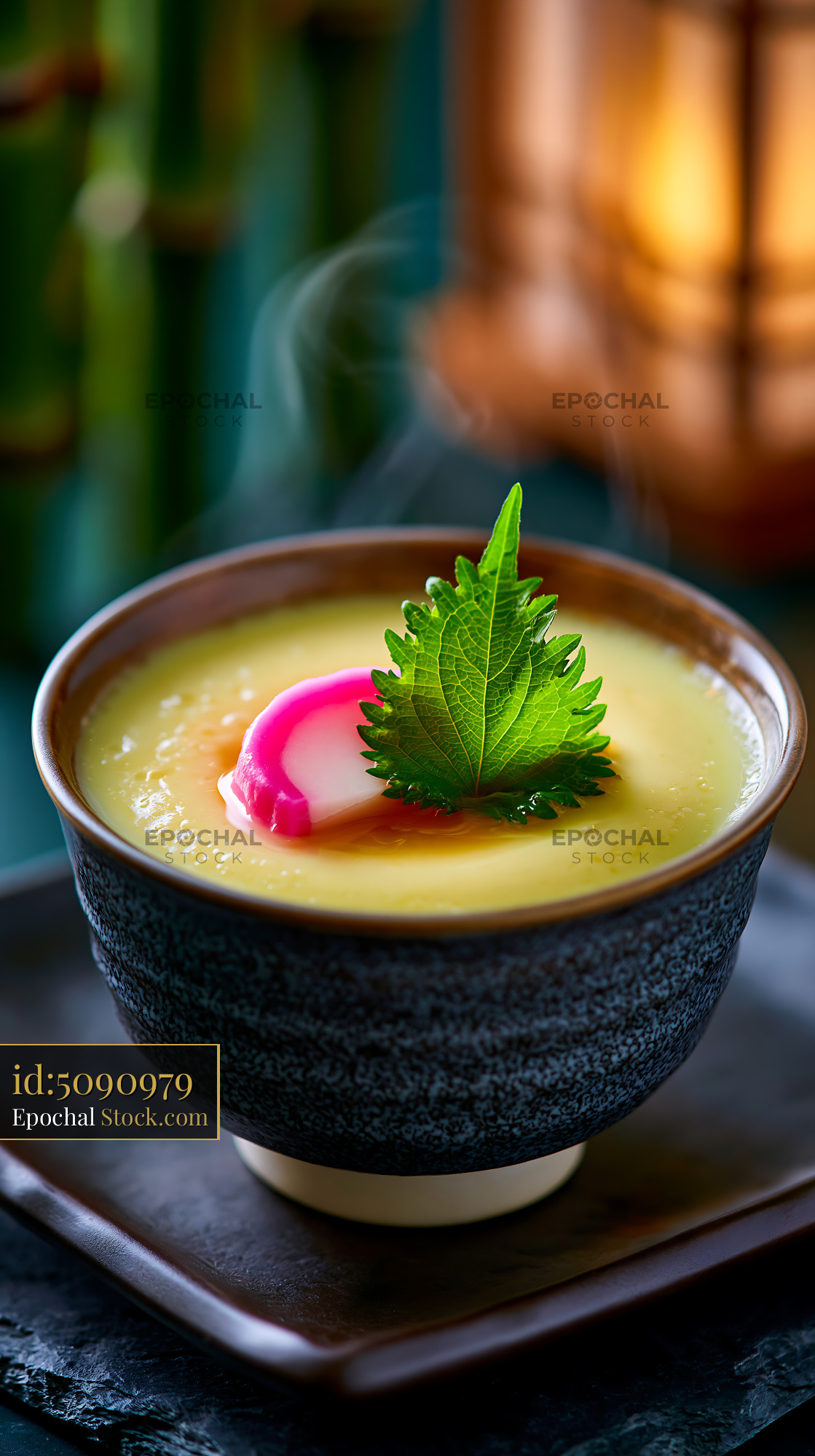 Steaming chawanmushi egg custard with kamaboko and shiso leaf - stock photo