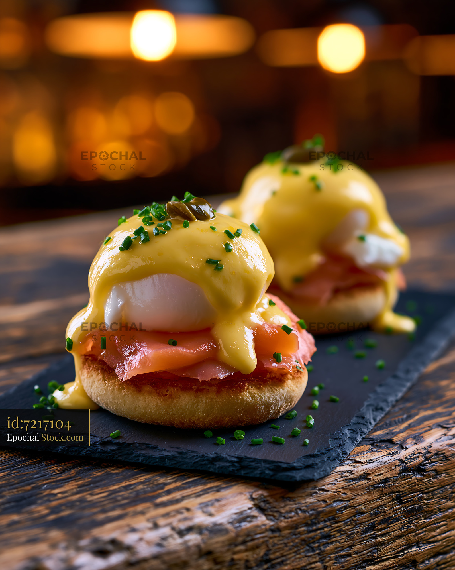 Eggs Neptune with smoked salmon and hollandaise sauce on slate board - stock photo
