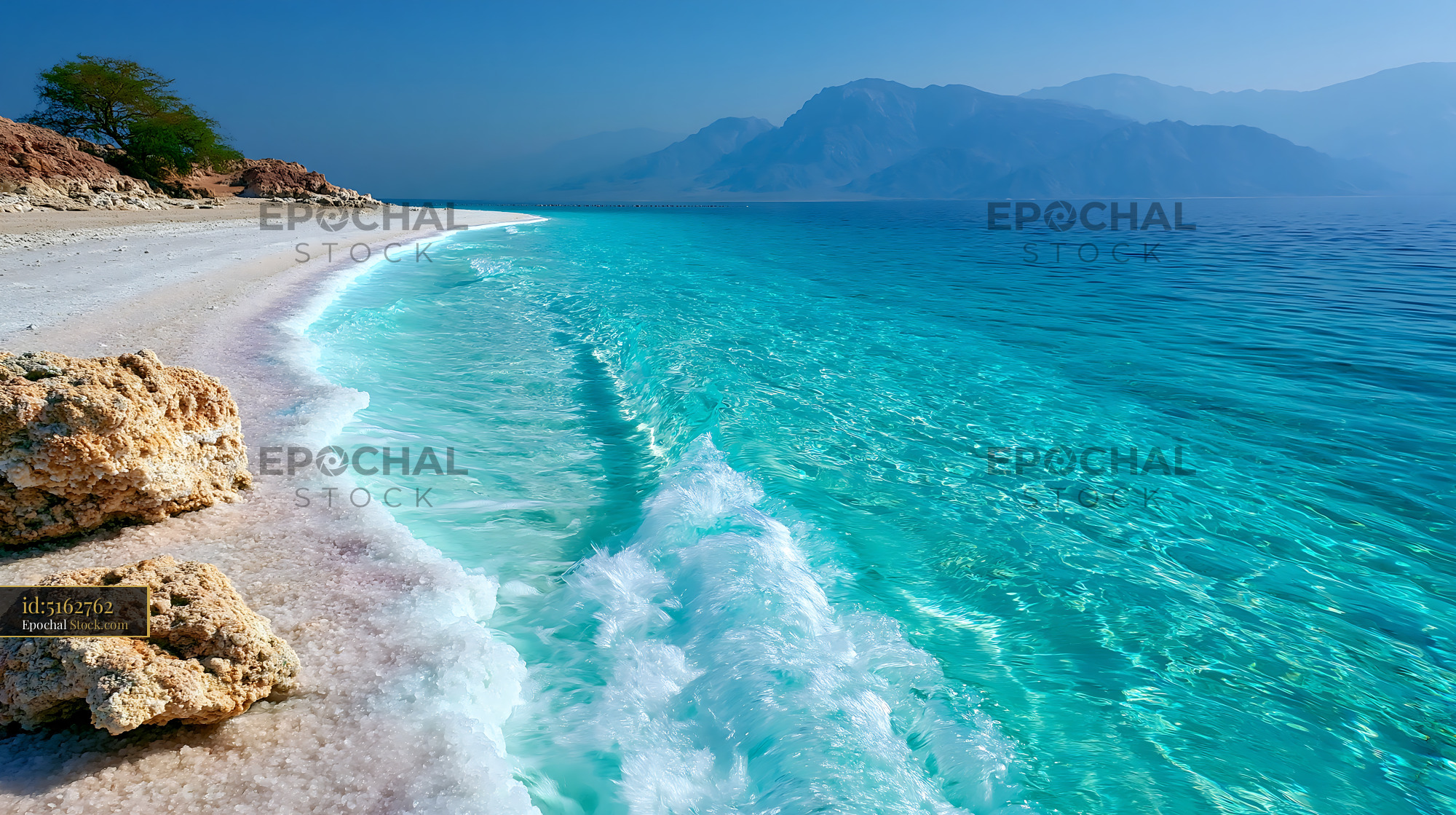 Pristine salar coastline with turquoise water and white salt rocks - stock photo