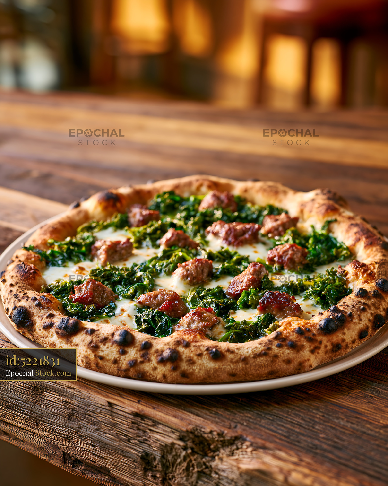Authentic friarielli sausage pizza on a rustic wooden table - stock photo