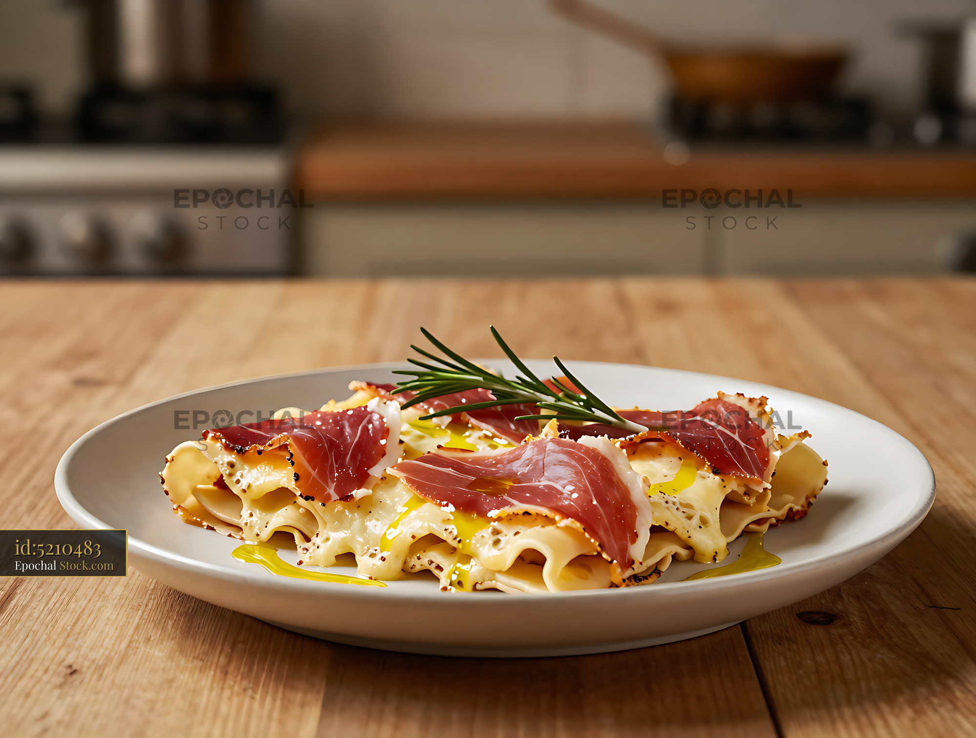 Crostoni di speck e fontina with rosemary on a wooden kitchen table - stock photo