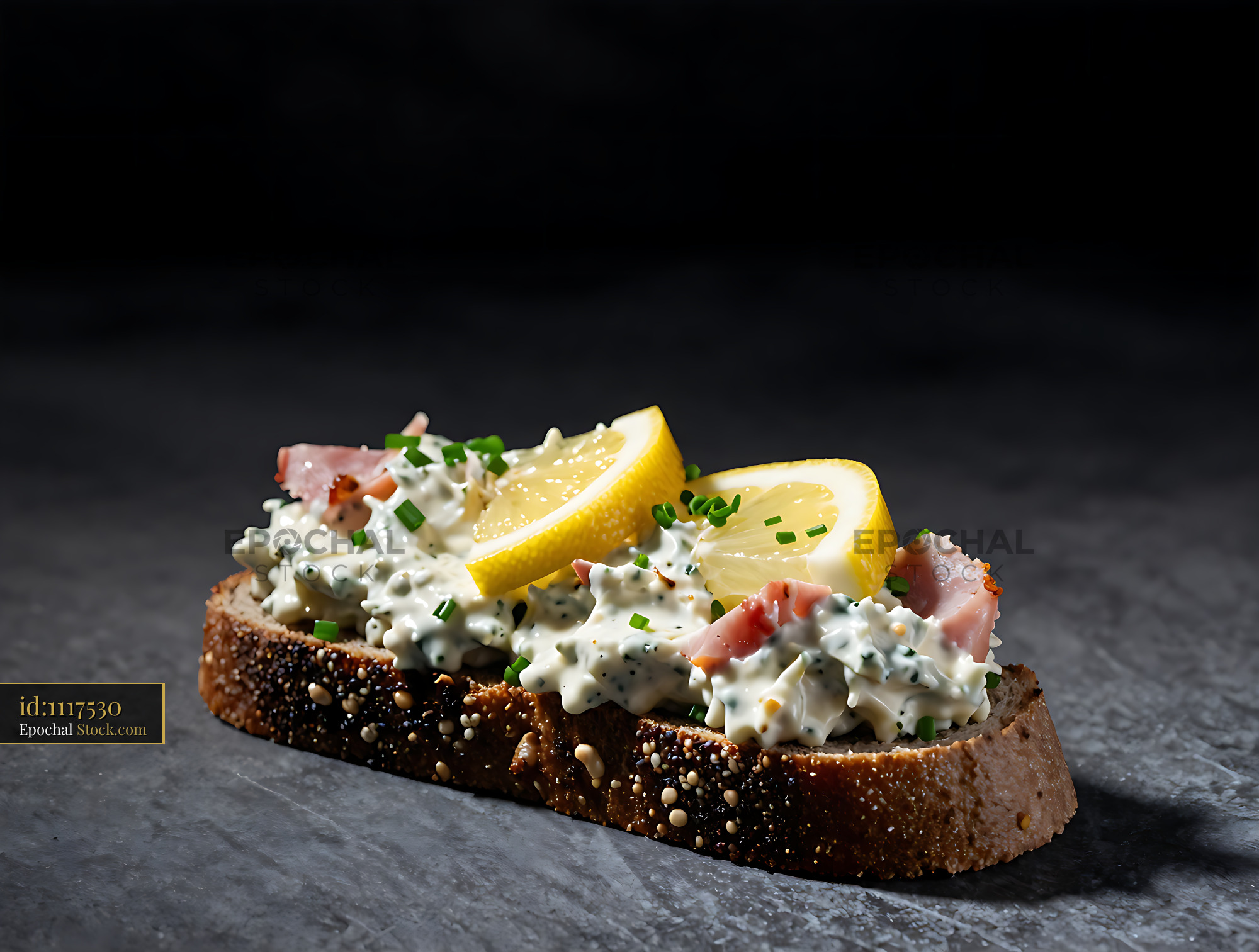 Traditional Danish ham salad on rye bread with lemon and chives - stock photo