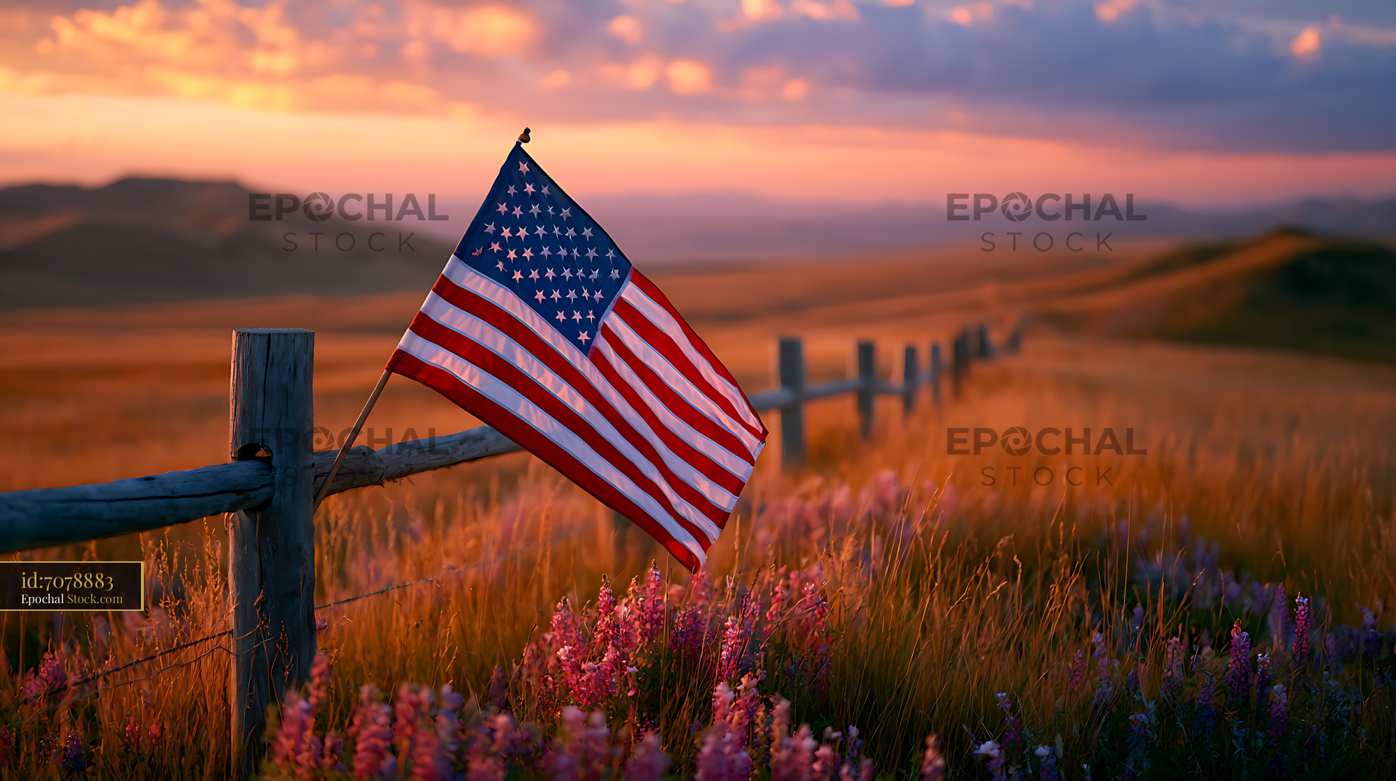 American flag on a rustic fence at a Wyoming ranch during sunset - stock photo