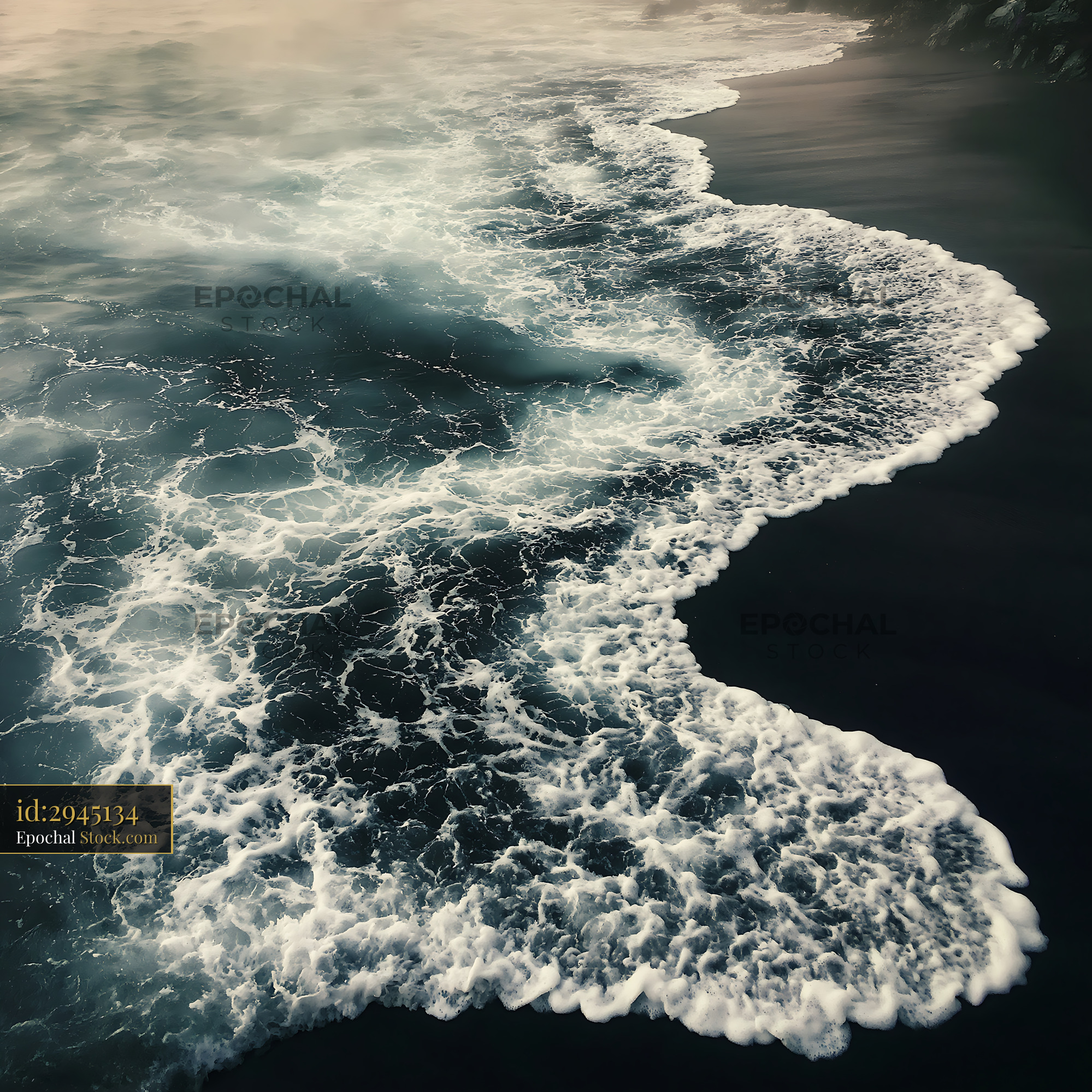 White sea foam washing over black sand beach at sunset - stock photo