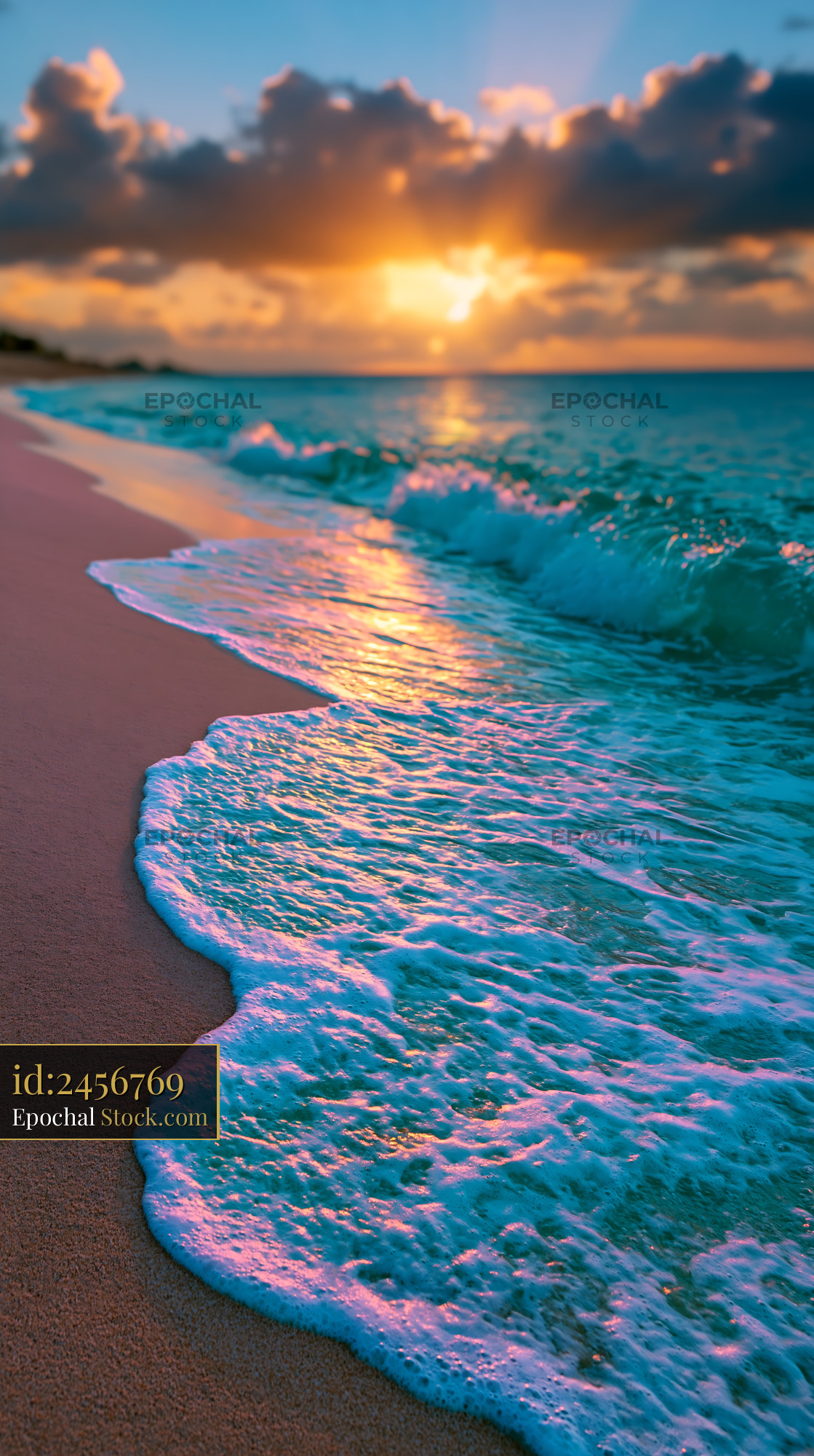Ocean waves washing onto sandy beach during a golden sunset - stock photo