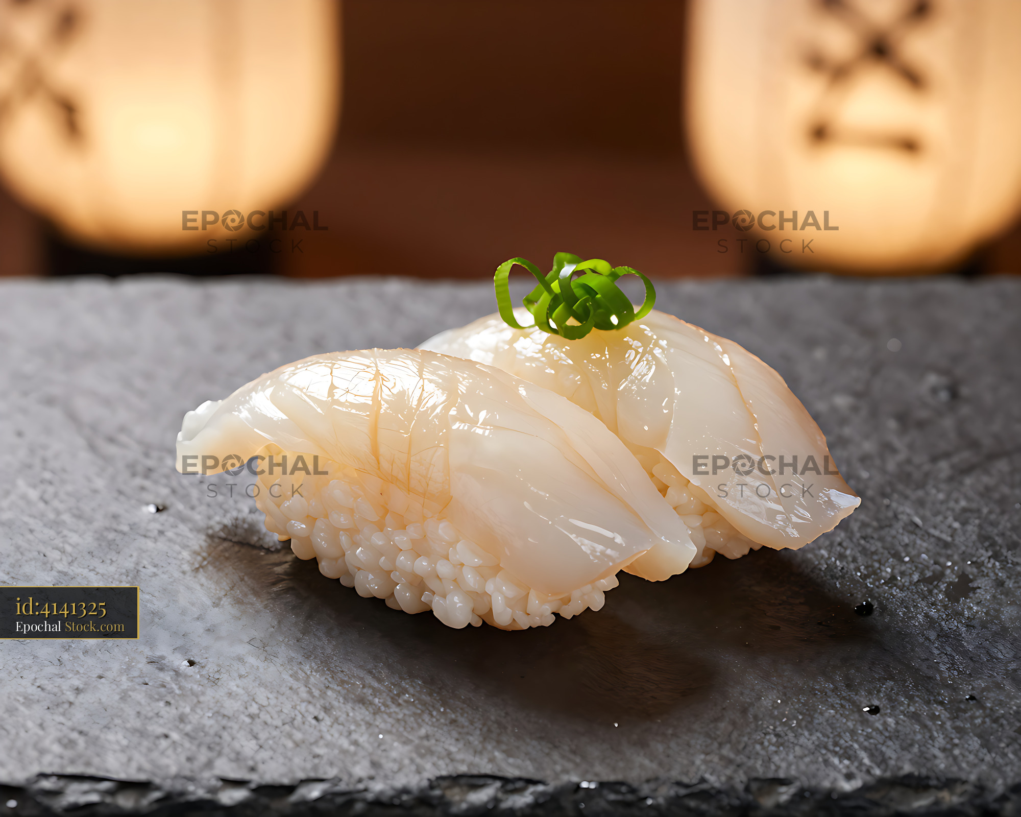 Fresh tachiuo nigiri sushi on a dark slate in a Japanese restaurant - stock photo