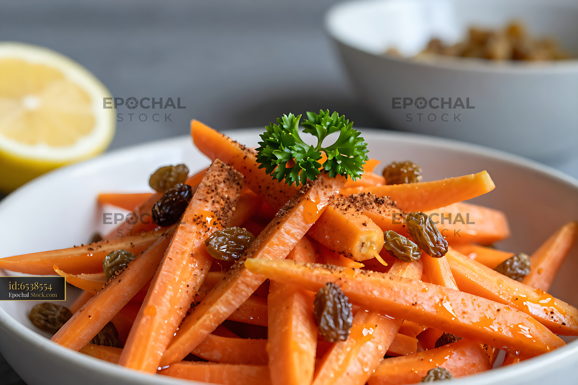 Moroccan carrot salad with orange and raisins in a white bowl - stock photo