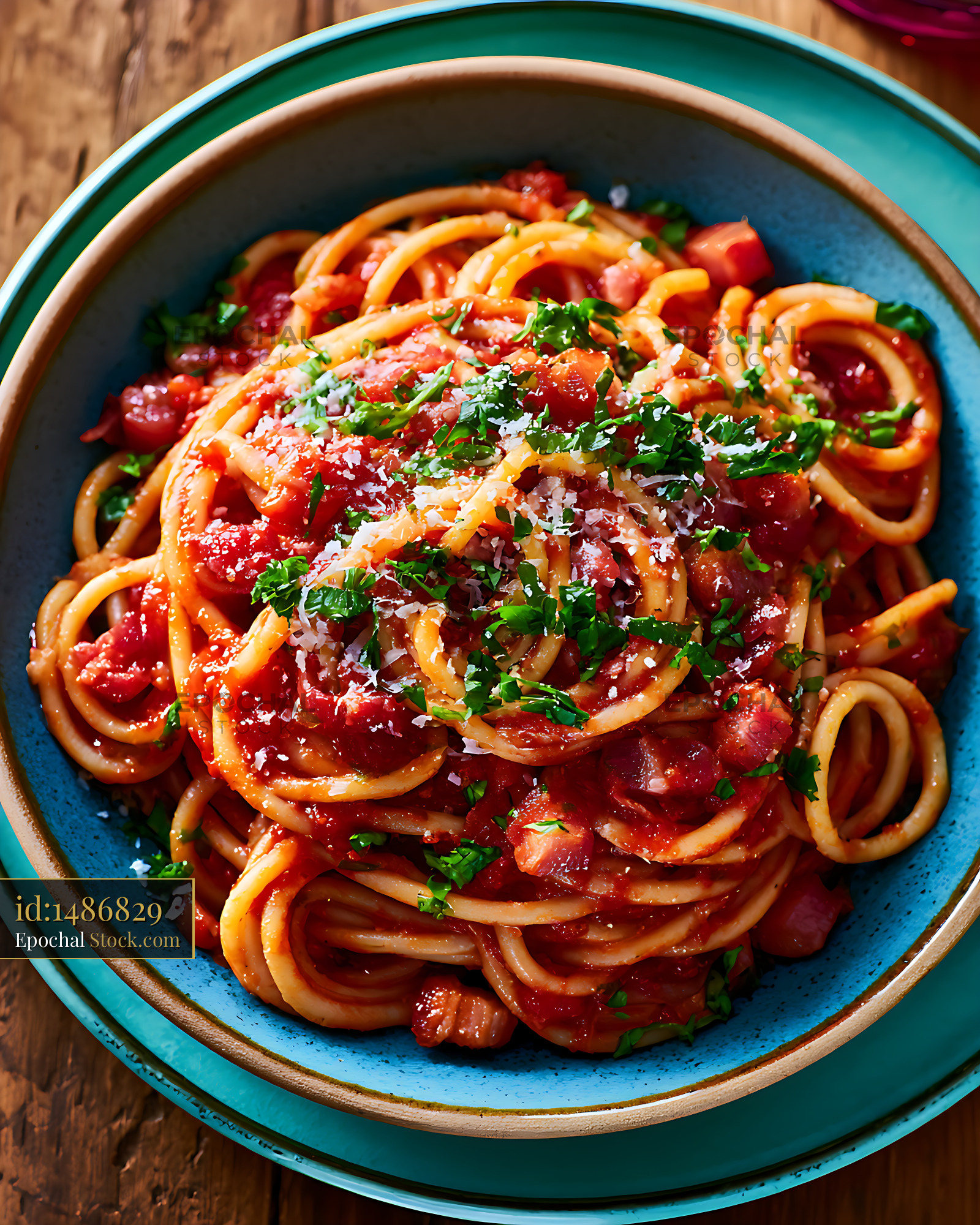 Pasta amatriciana with guanciale and pecorino cheese in a blue bowl - stock photo