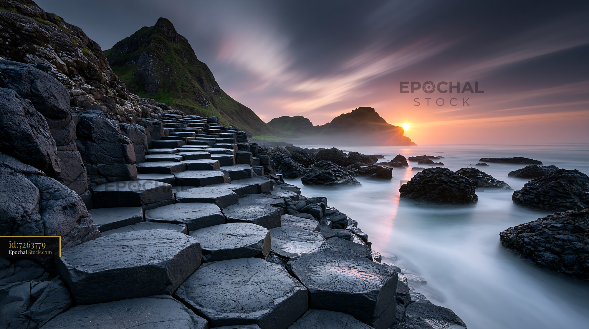 Basalt giants causeway columns at sunset on the Northern Ireland coast - stock photo