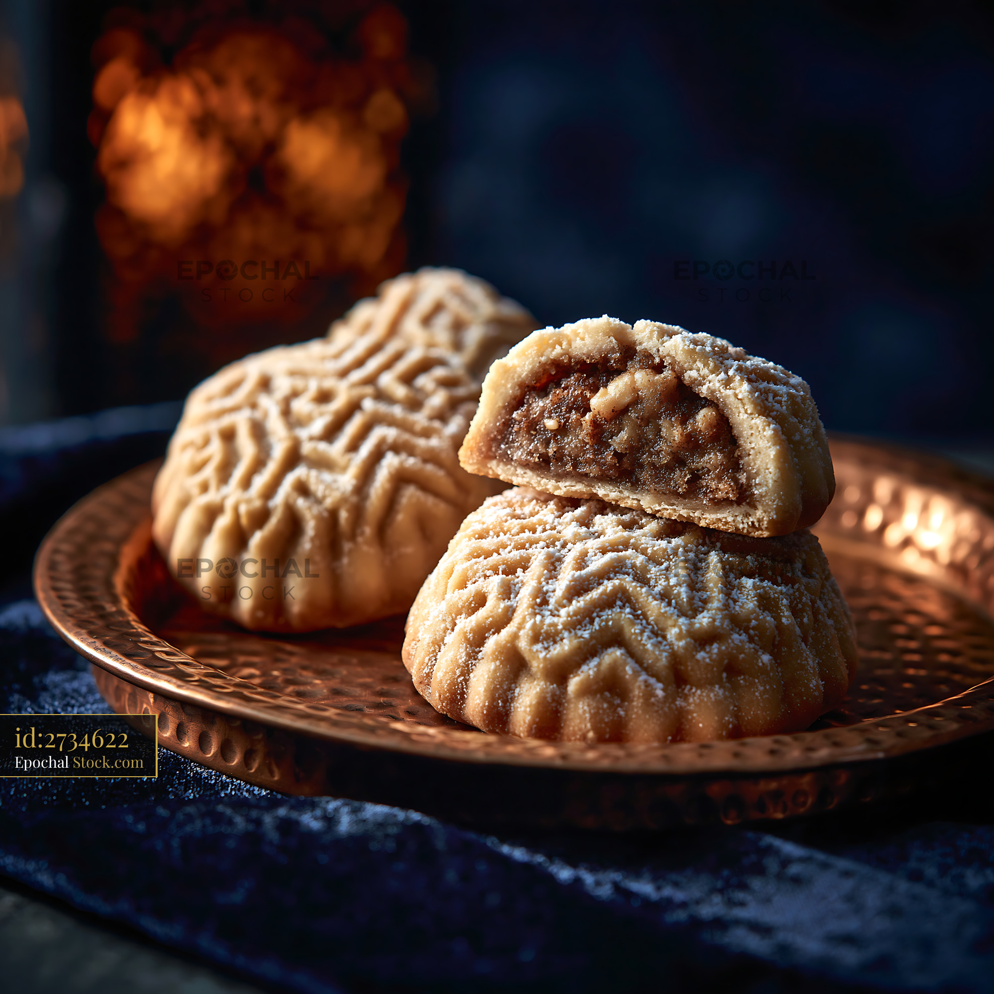 Traditional walnut maamoul biscuits on a copper plate in warm light - stock photo