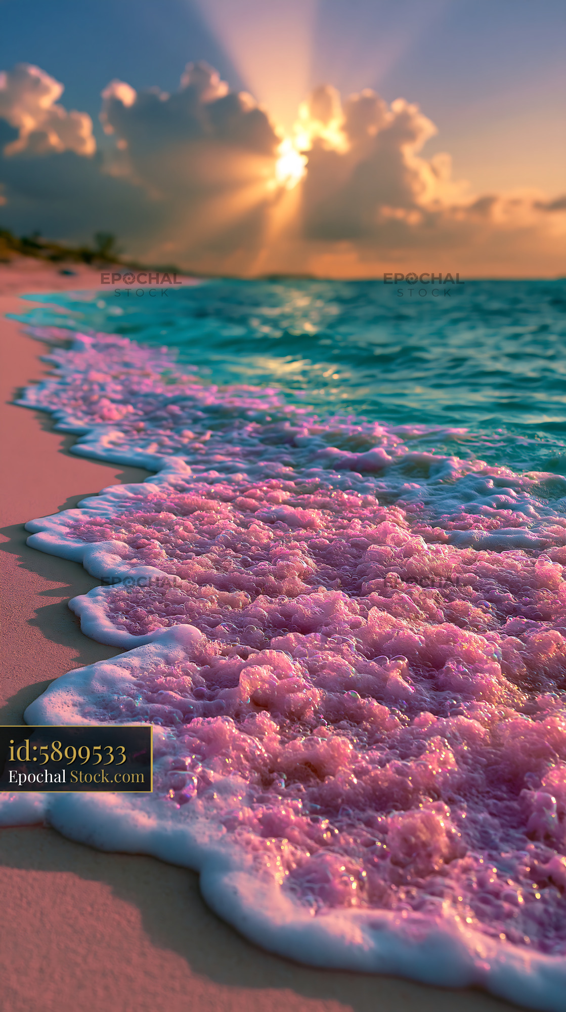 Pink sea foam washing onto a tropical beach at sunset with sun rays - stock photo