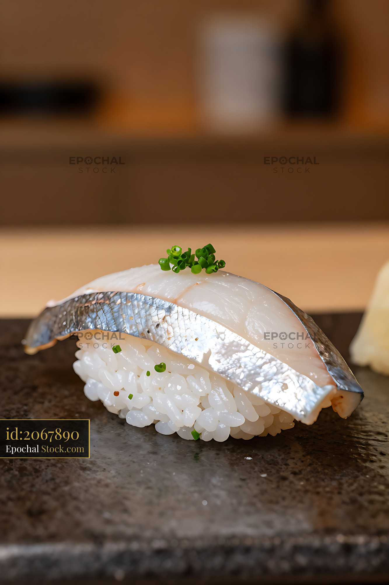 Fresh sayori nigiri sushi with silver skin on a dark stone plate - stock photo