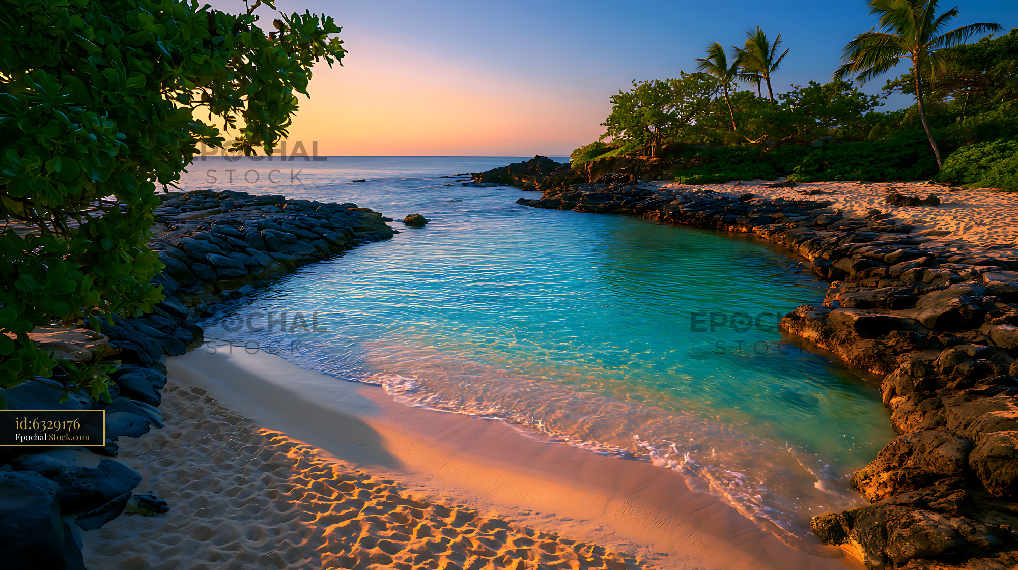 Tropical beach cove with turquoise water and palm trees at sunset - stock photo