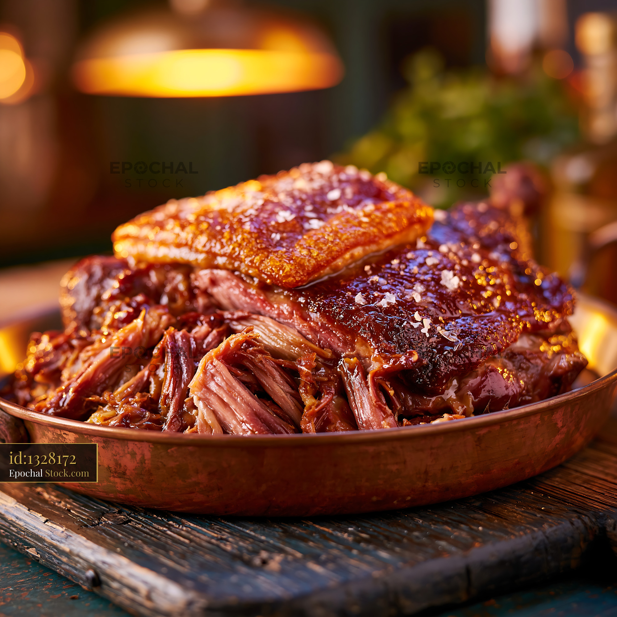Confit de canard meat with crispy skin served in a rustic copper pan - stock photo