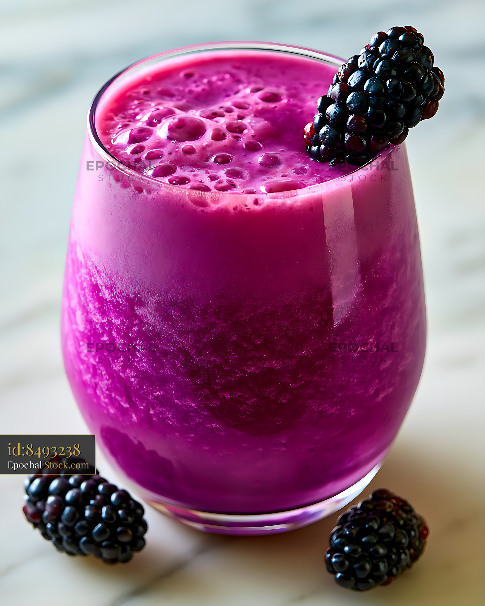 Amethyst purple smoothie with fresh blackberries on marble surface - stock photo
