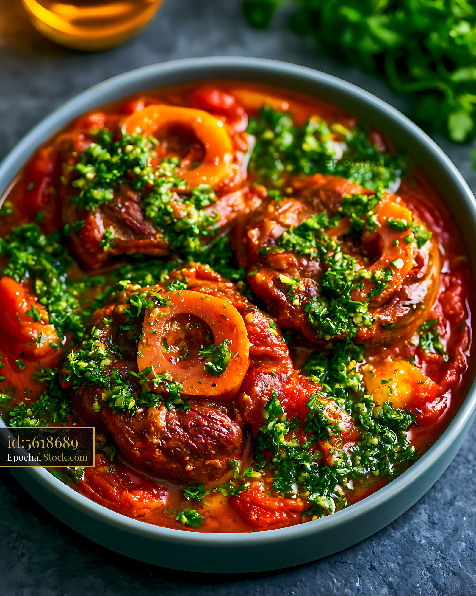 Traditional ossobuco alla milanese with fresh gremolata in a bowl - stock photo