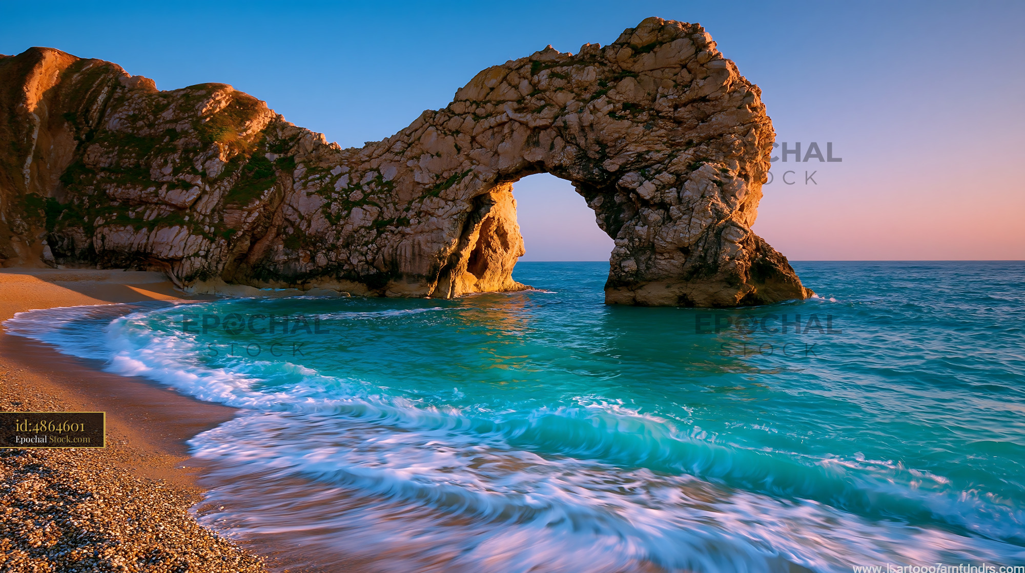 Limestone sea arch at a pebble beach during golden hour - stock photo