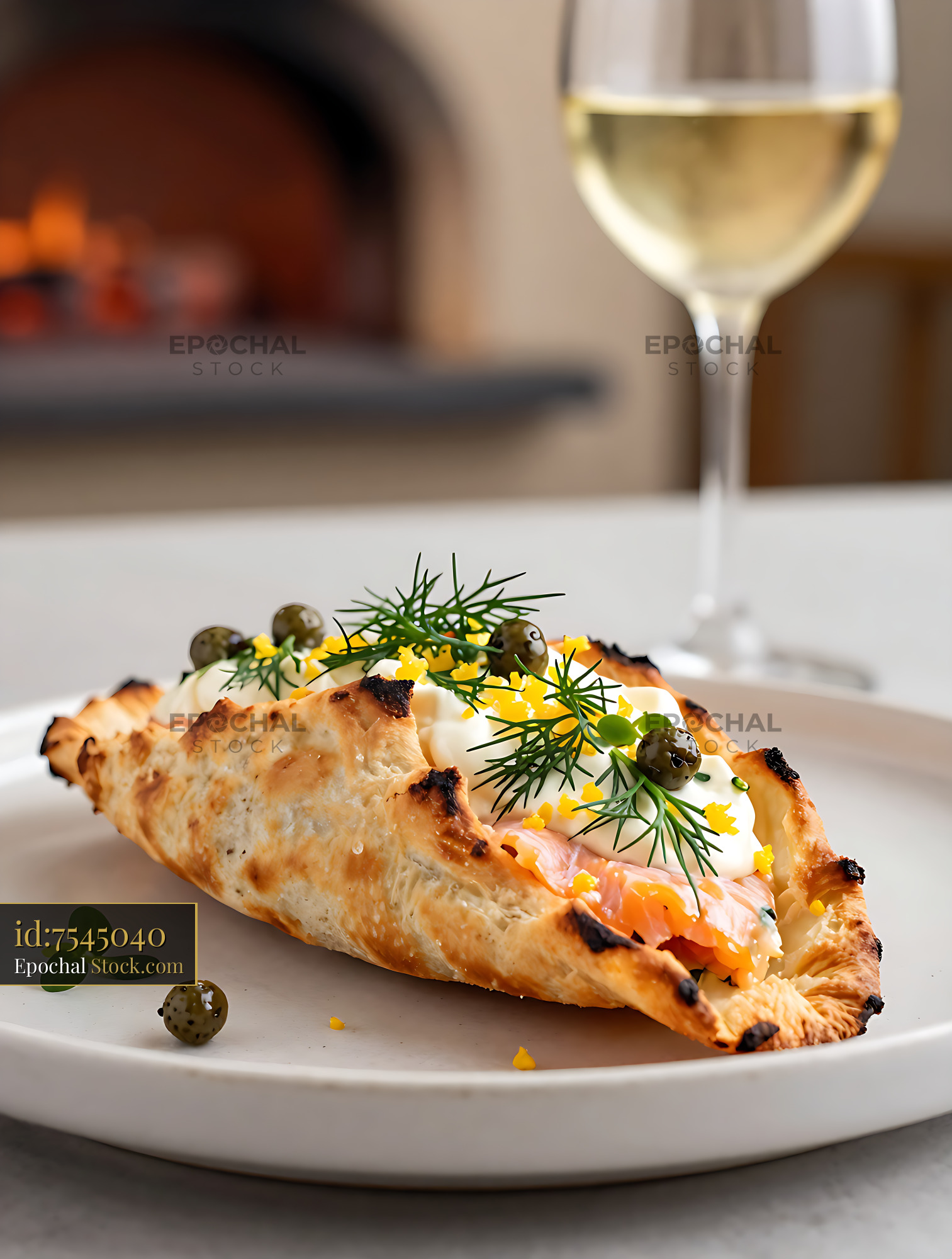 Gourmet calzone salmon-dill with caper crown and white wine - stock photo