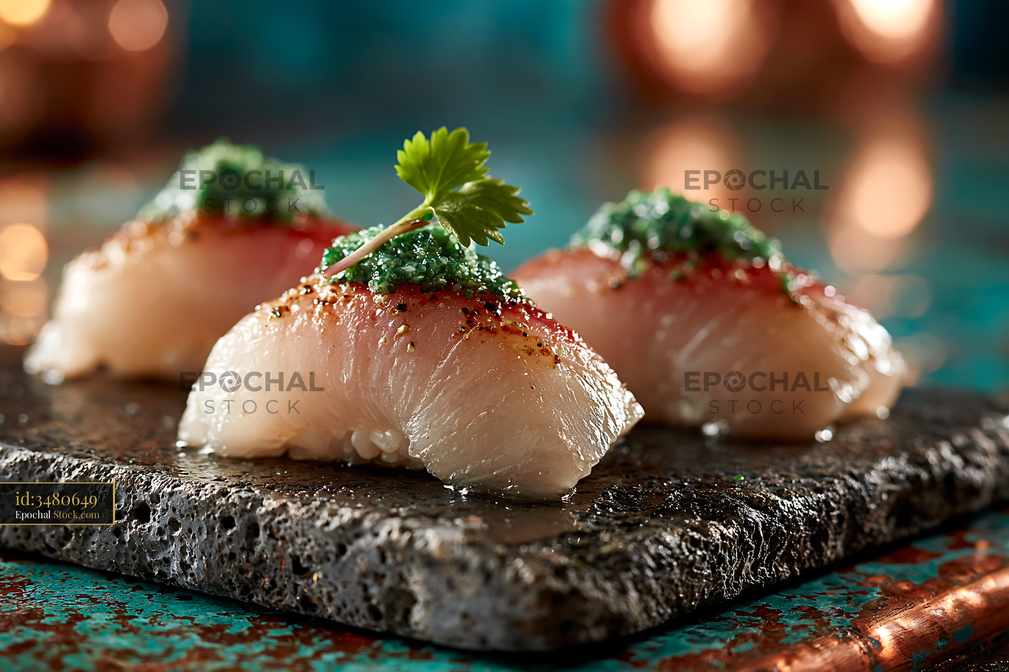 Gourmet yuzu kosho yellowtail sushi on a dark stone platter - stock photo
