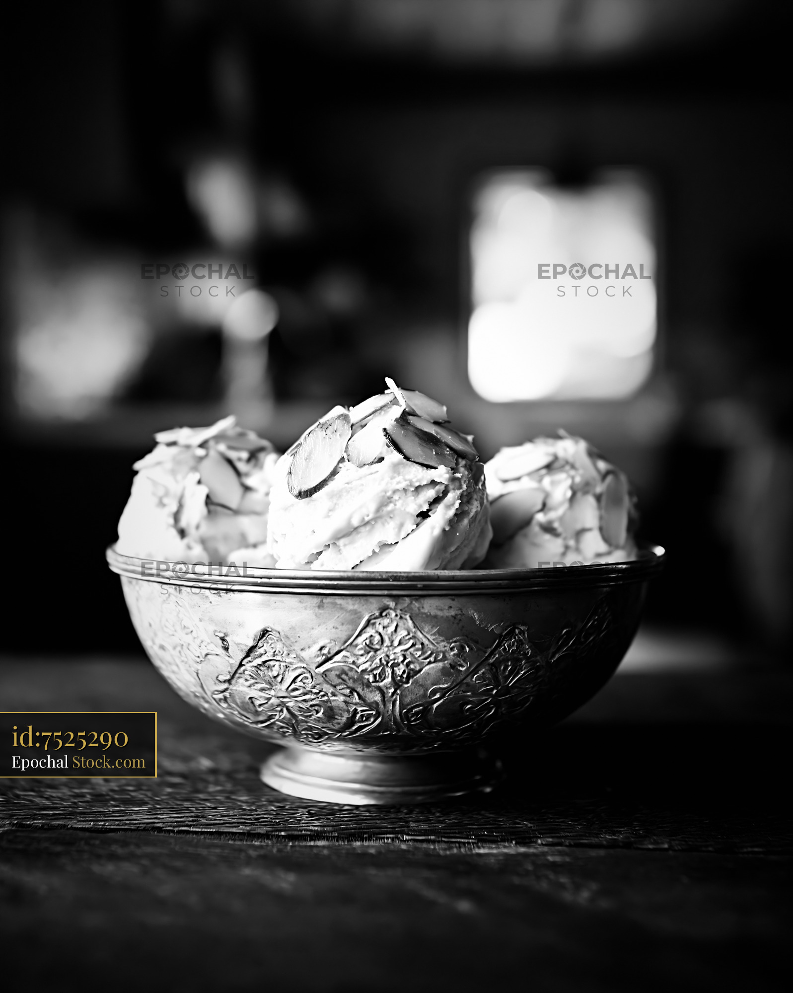 Three scoops of almond paste ice cream in a vintage silver bowl - stock photo