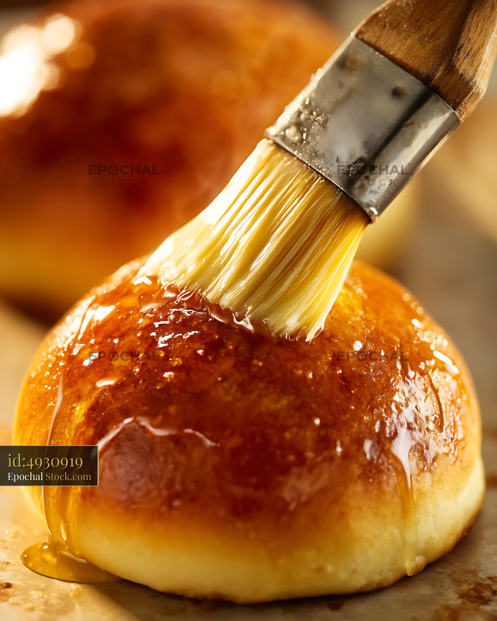 Bierocks Being Glazed with Pastry Brush in Warm Kitchen Light - stock photo