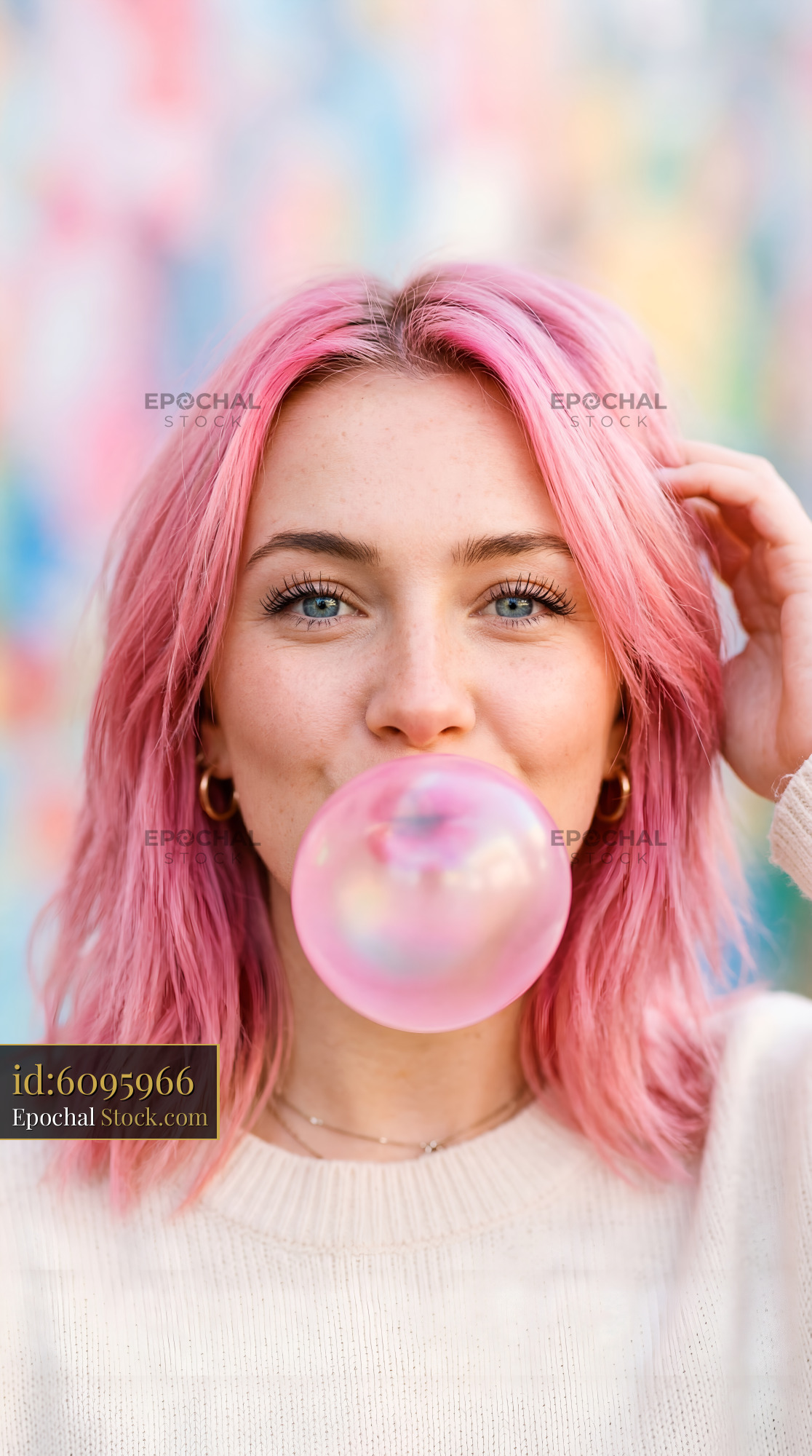 Girl blows bubble gum in colorful setting Premium Stock Photo