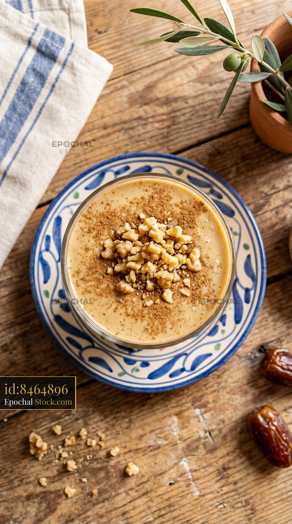 Tahini Date Shake with Walnuts on Blue Plate - stock photo