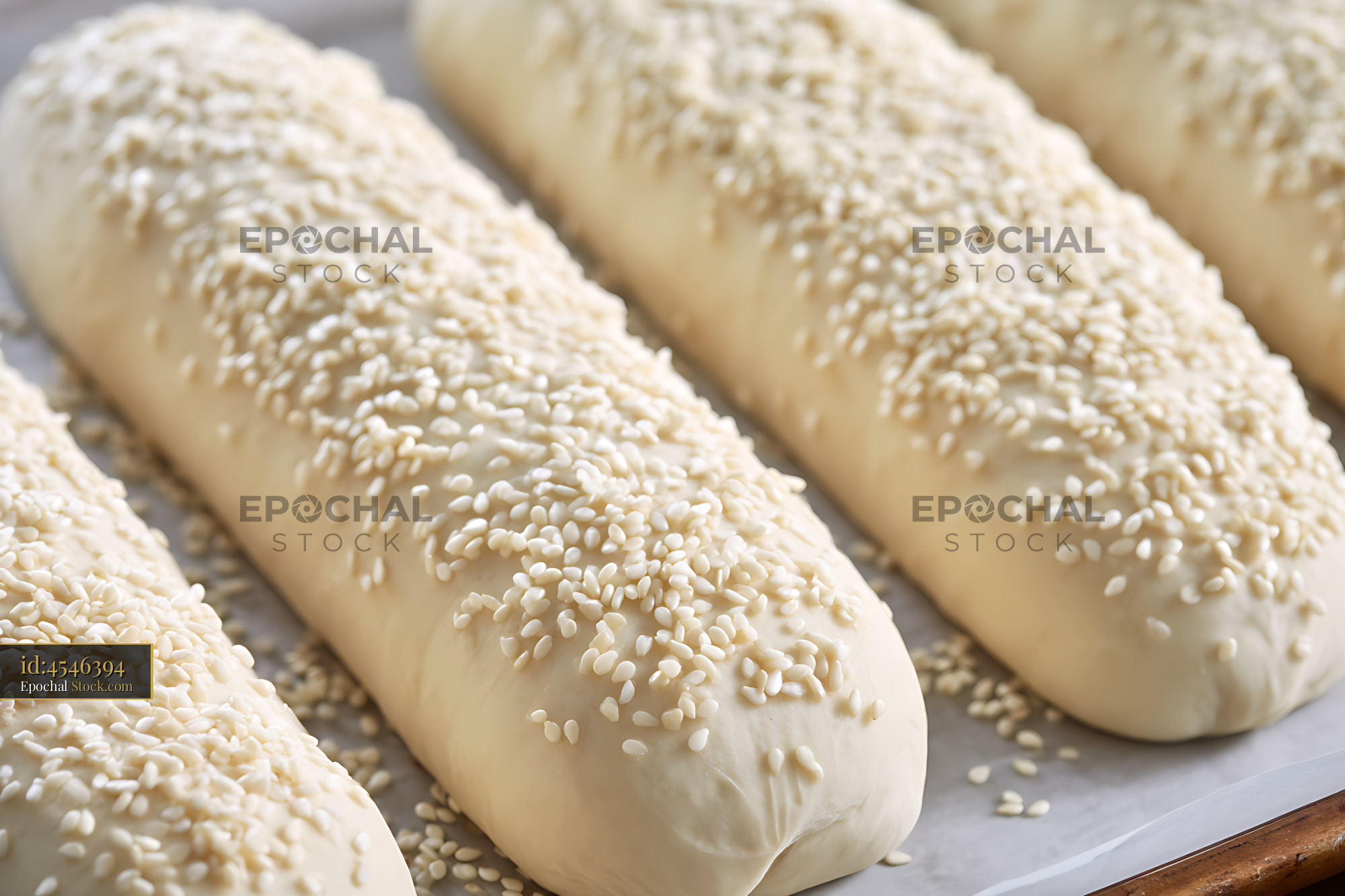 Traditional Bierocks Pastries Topped with Sesame Seeds on Baking Paper - stock photo