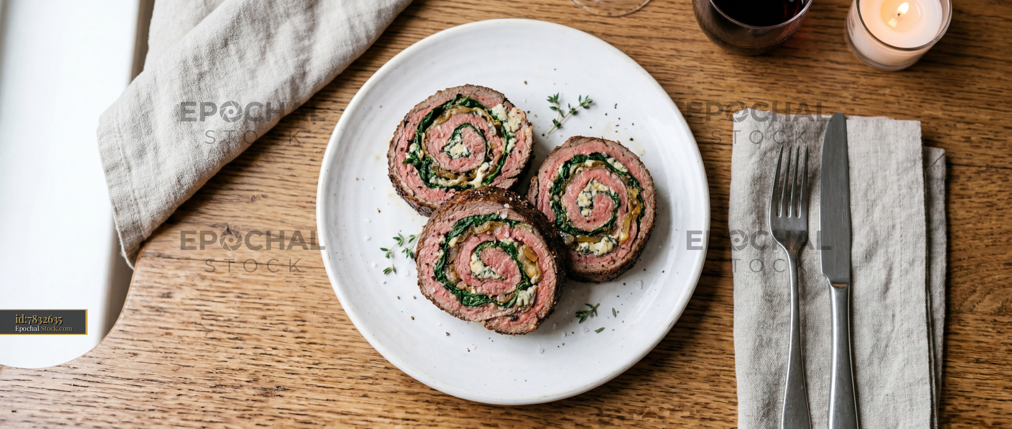 Sliced Beef Roulade with Spinach on White Plate - stock photo