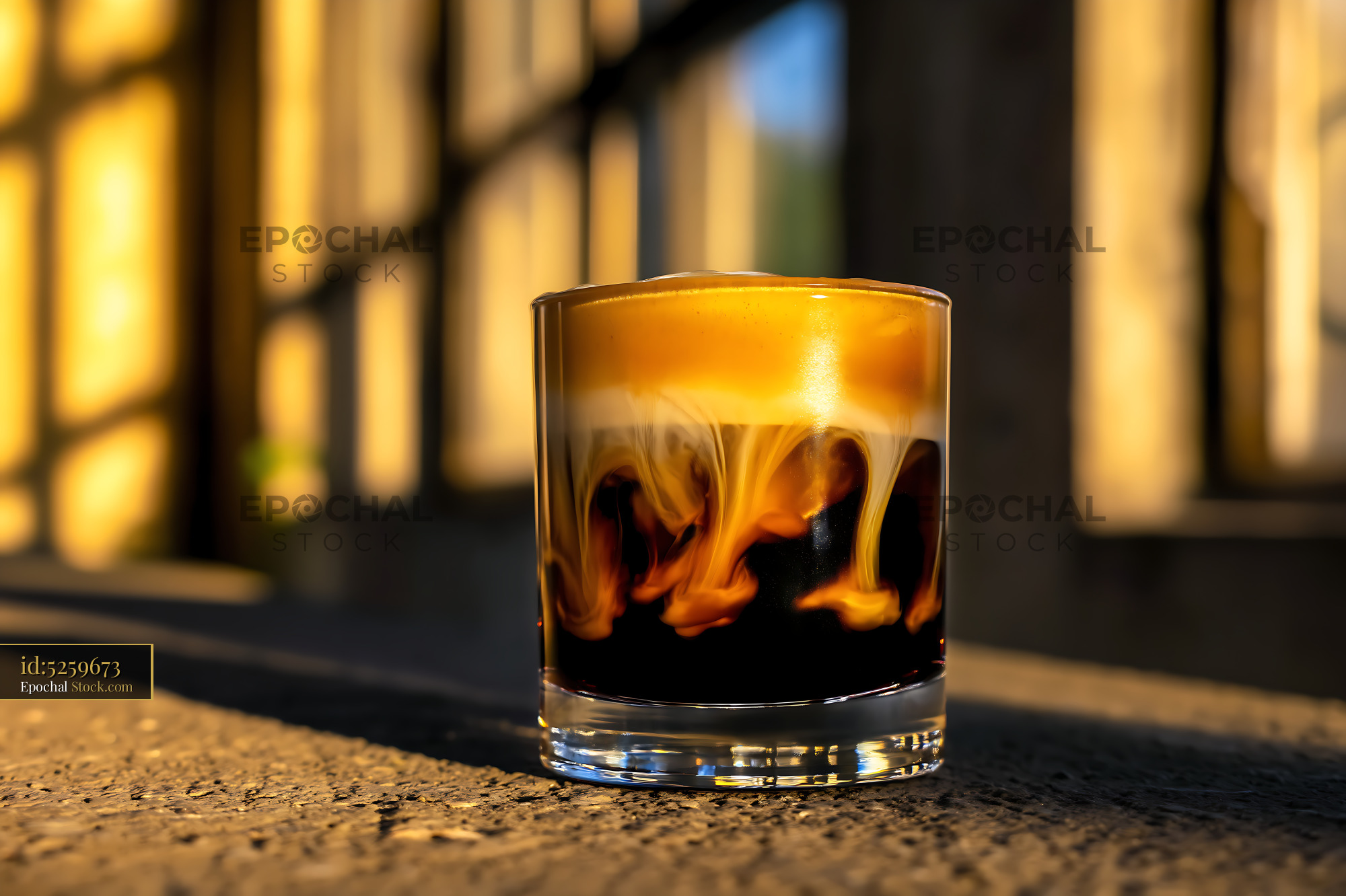 Nitro Caramel Coffee Glass in Golden Sunlight - stock photo