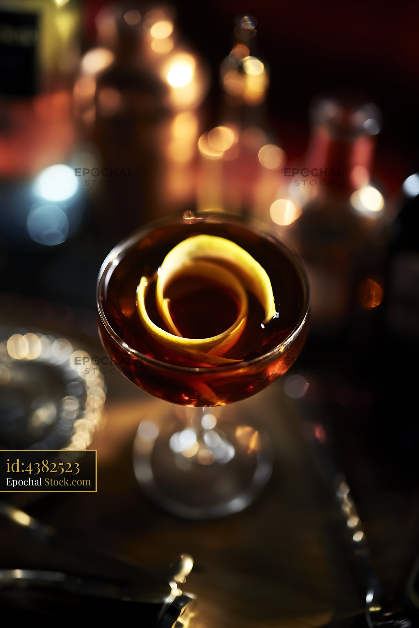 Amber Whiskey Glass Swirl Against Bokeh Lights - stock photo