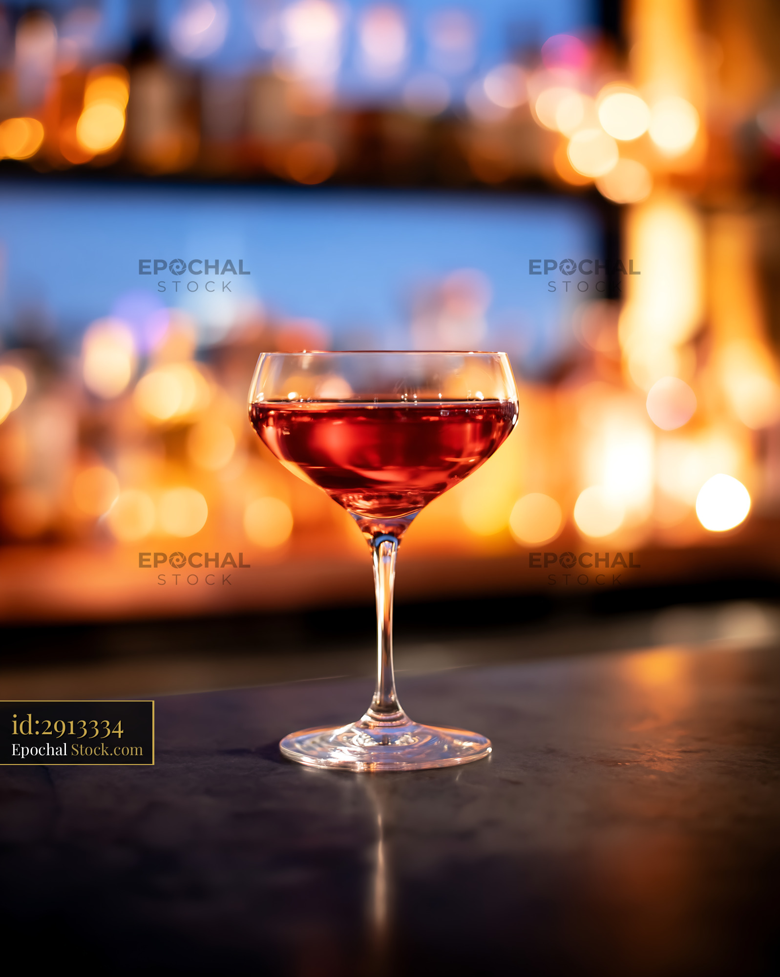 Red Cocktail in Coupe Glass at Upscale Bar - stock photo