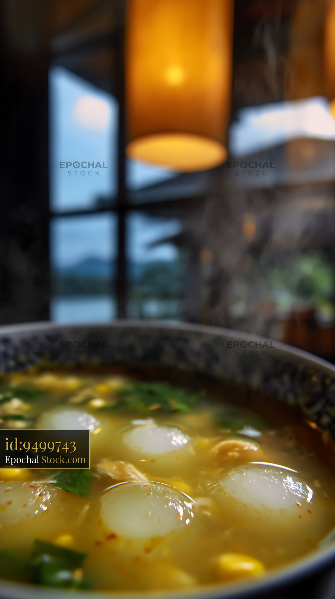 Steaming Lor Mee Soup with Dumplings in Warm Restaurant - stock photo